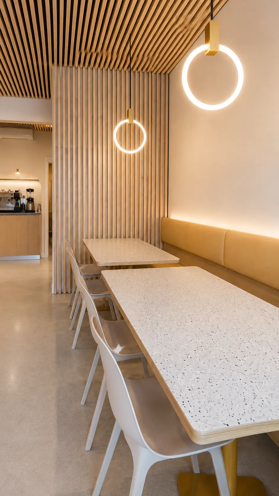 Downtown Vancouver restaurant renovation featuring a wood-slat ceiling, custom millwork, lighting and coordinated hospitality finishes