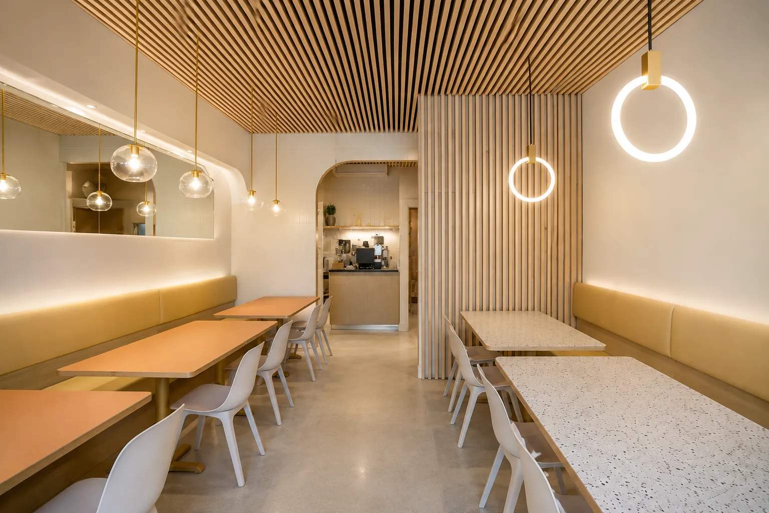 Completed restaurant renovation in Downtown Vancouver featuring custom dining areas, curved architectural details, wood finishes and commercial lighting