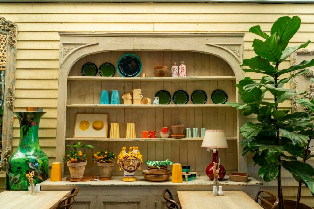 Hutch with colourful plates, vases and plants