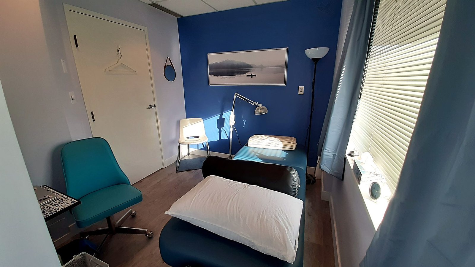 Treatment room with a navy accent wall and new vinyl plank flooring