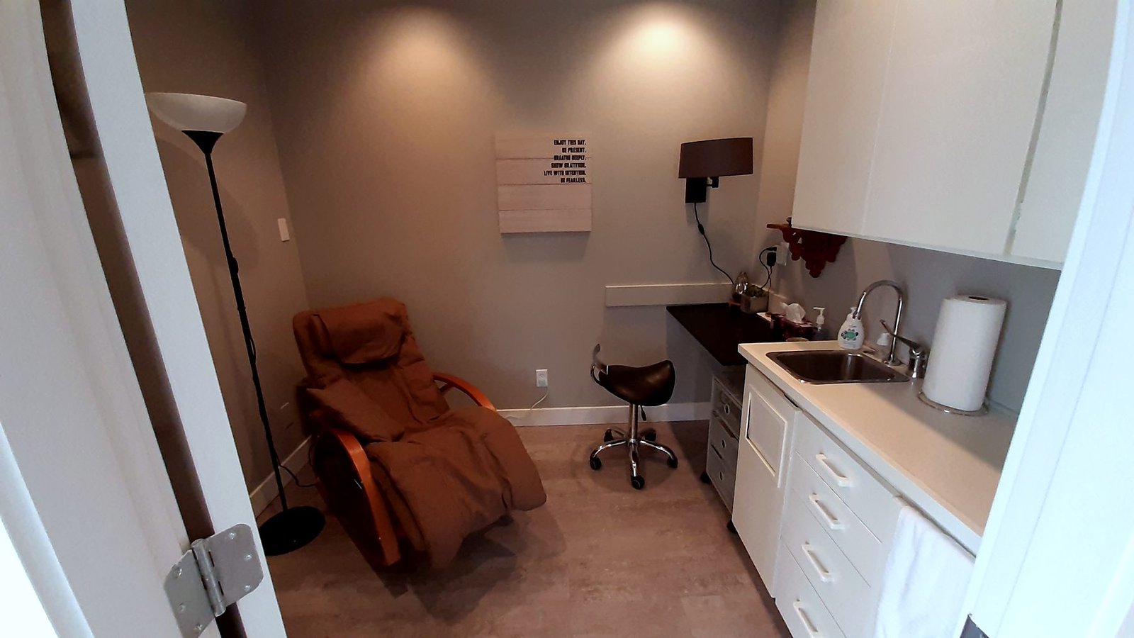 Treatment room with sink and cabinets after the office renovation