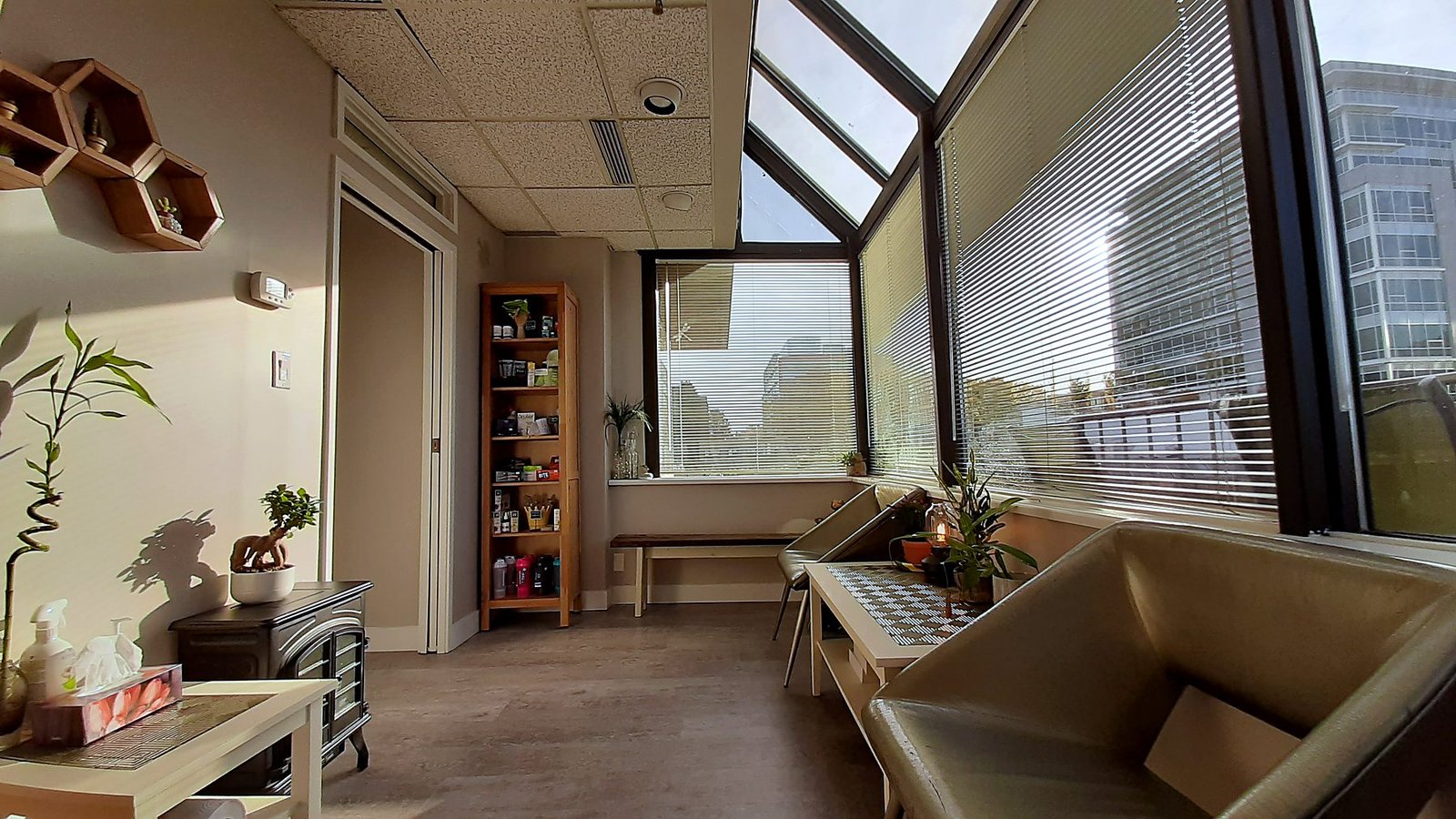 Bright waiting room with new vinyl plank flooring and fresh paint in a Vancouver chiropractic office