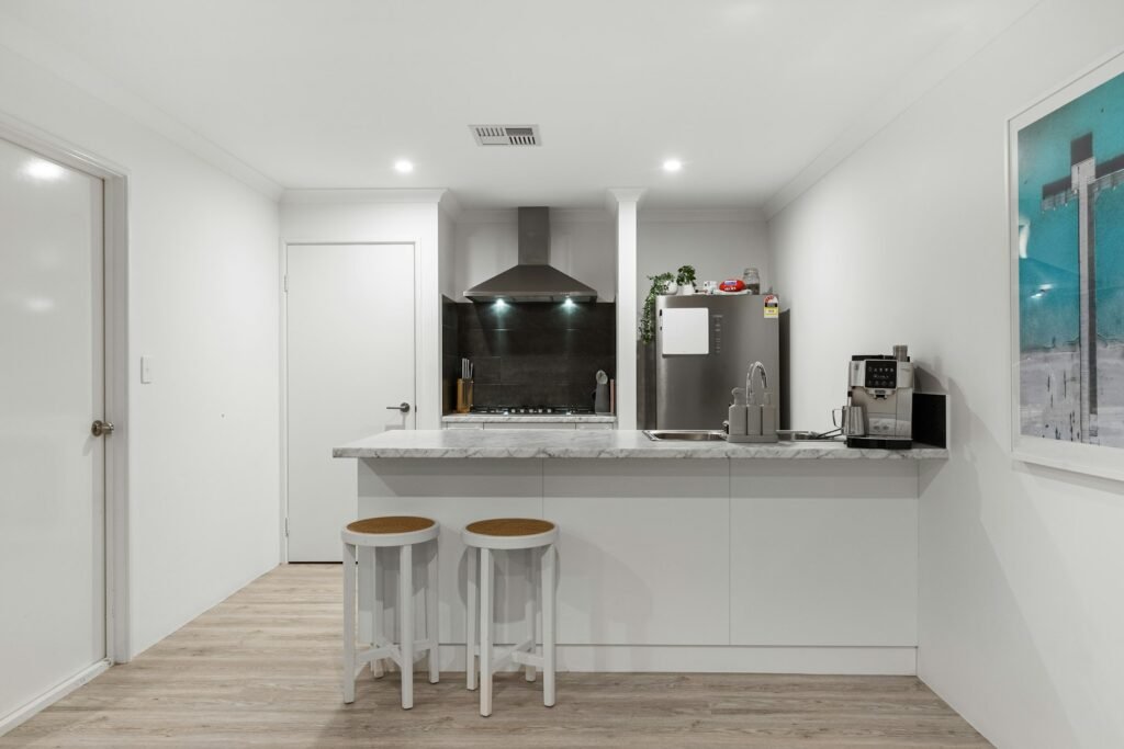 Bright kitchen with white walls and wood floors