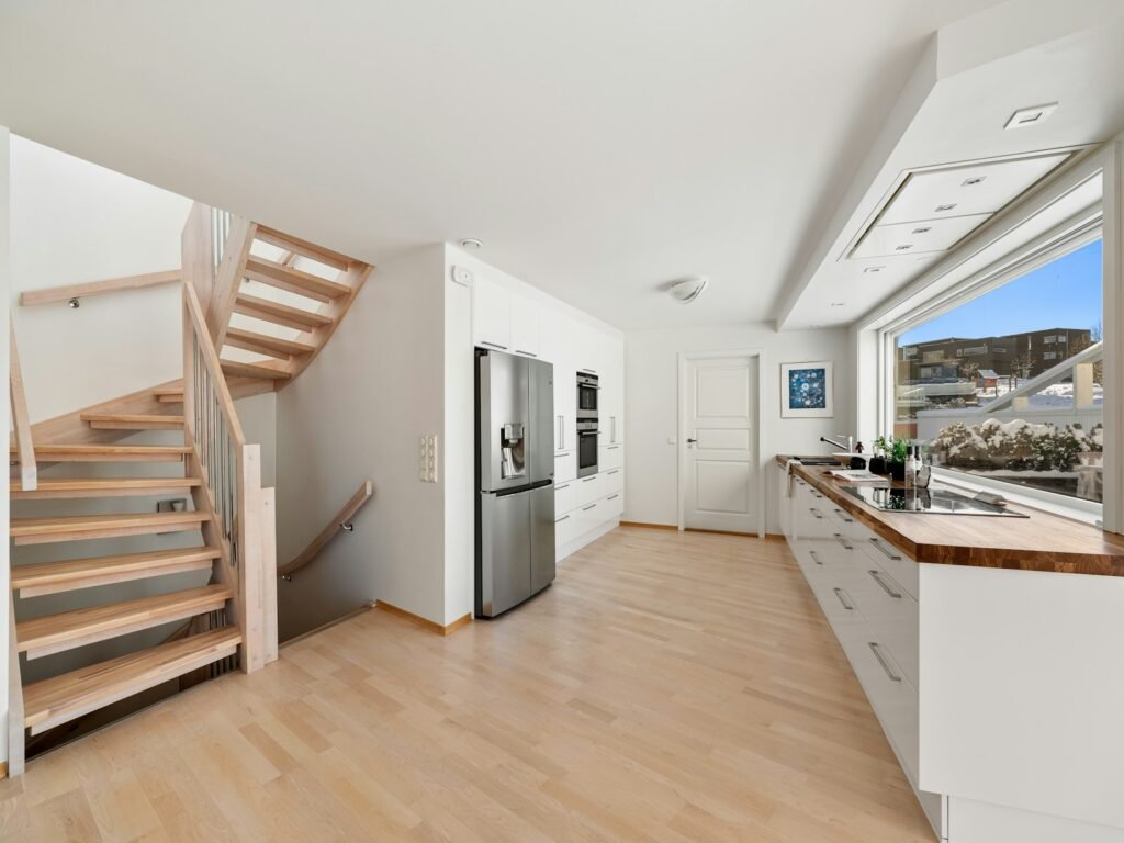 Airy kitchen with open staircase