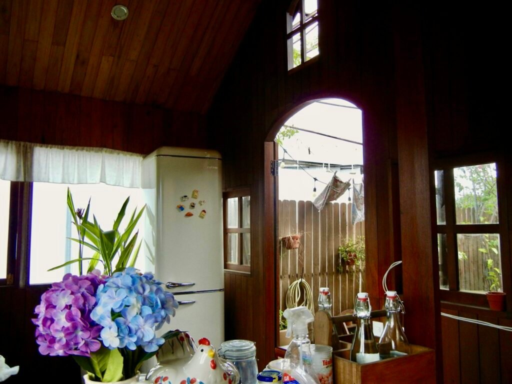 Rustic wooden cottage kitchen with vintage refrigerator