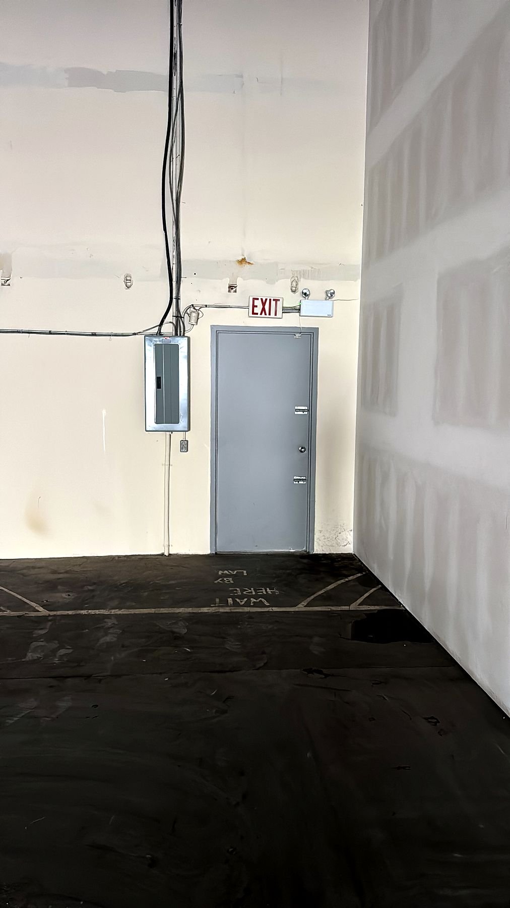 Drywall finished where the new demising wall meets the existing warehouse wall