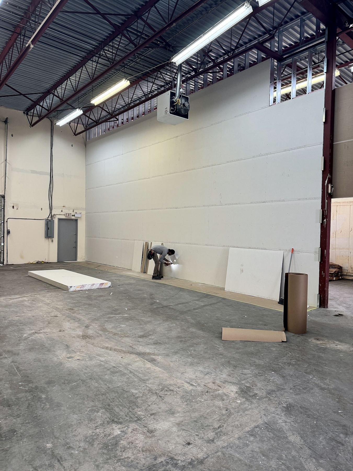 Drywall being installed on the new warehouse demising wall