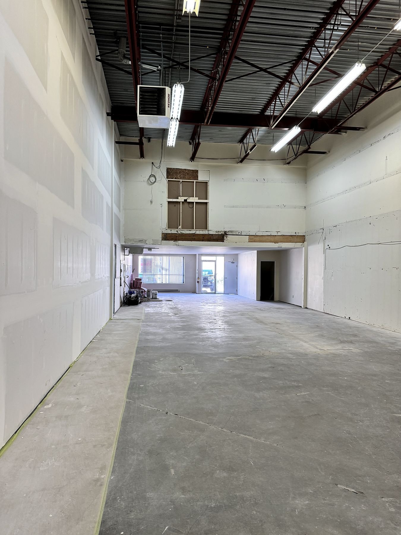 Taped and mudded demising wall in a Delta warehouse