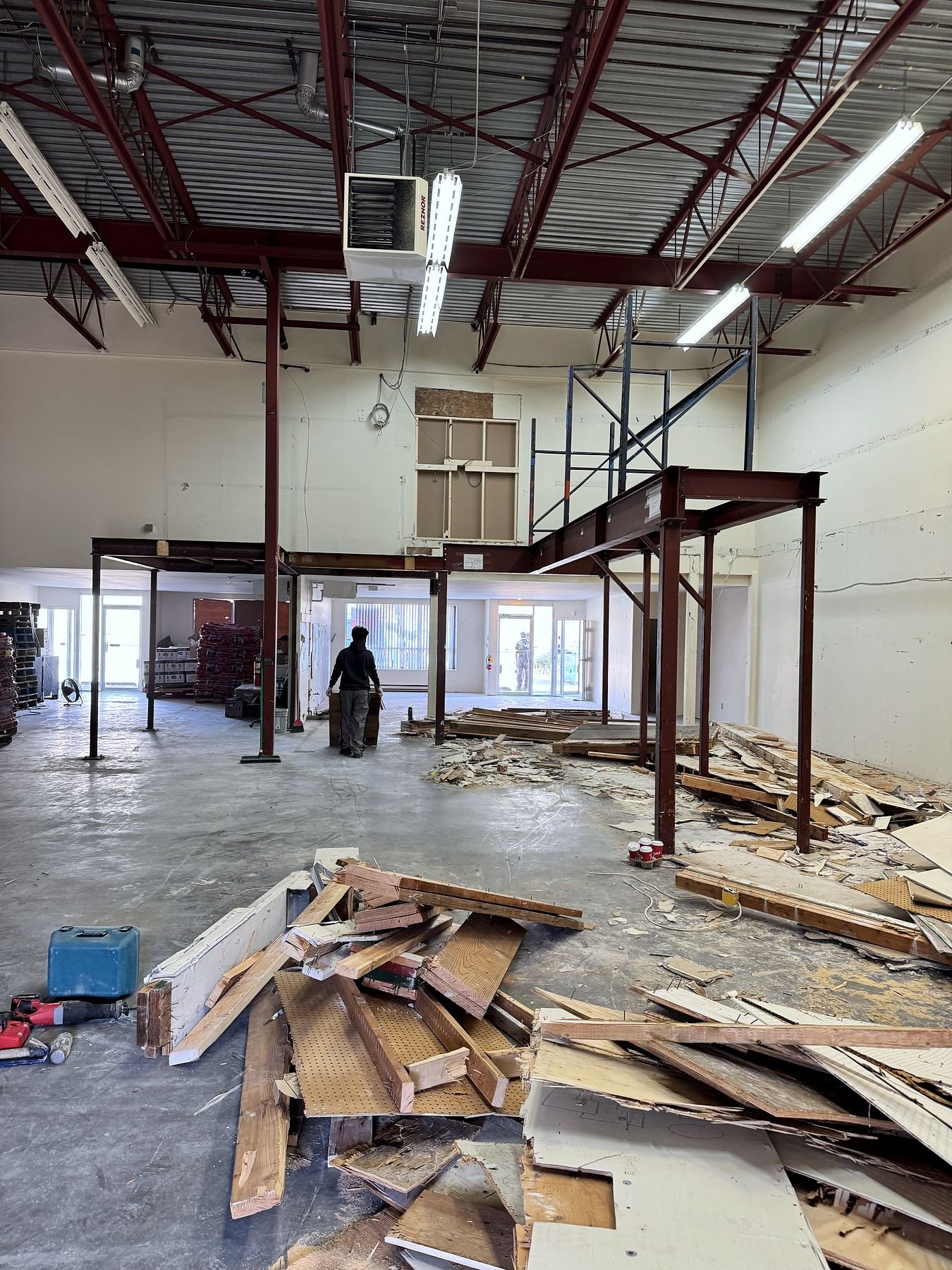 Mezzanine decking and framing being demolished in the warehouse