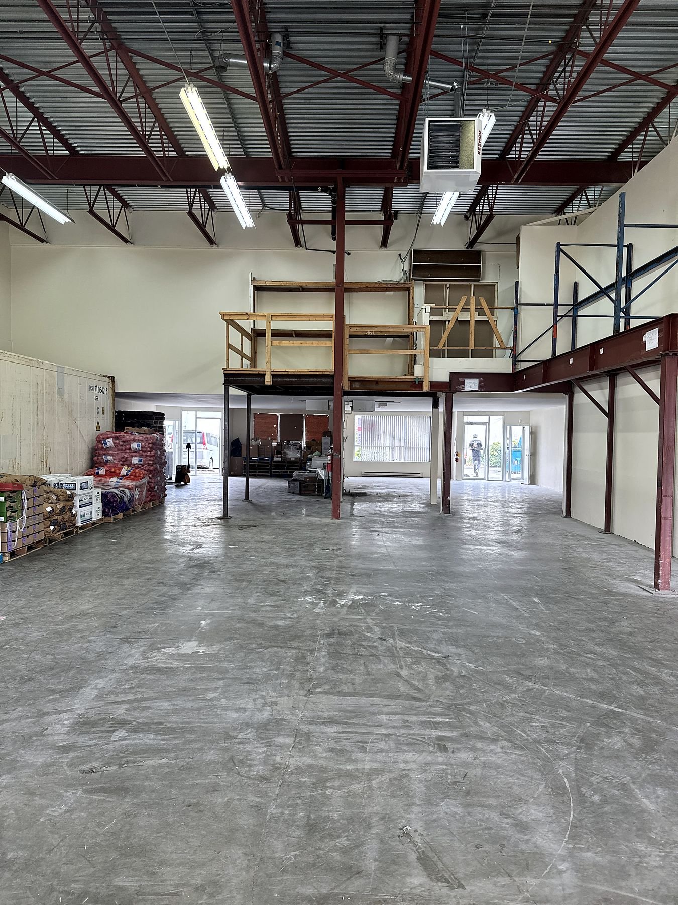Steel mezzanine structure across the warehouse floor before removal