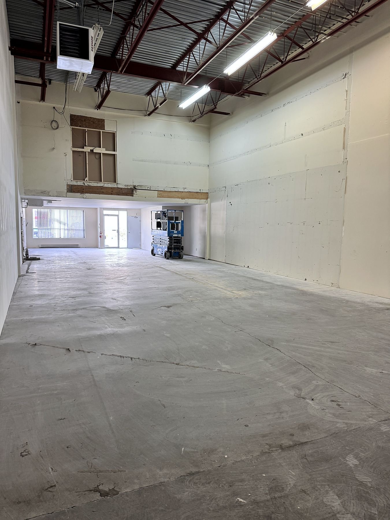 Open Delta warehouse unit after the steel mezzanine was removed, with the new demising wall on one side