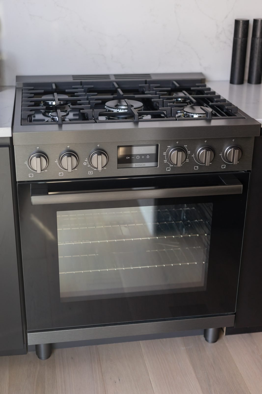 30-inch dual-fuel range under a hidden hood insert in a Downtown Vancouver condo kitchen