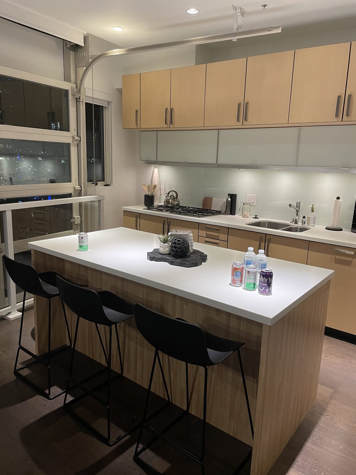 Before: maple slab cabinets and a white island in a Downtown Vancouver loft kitchen