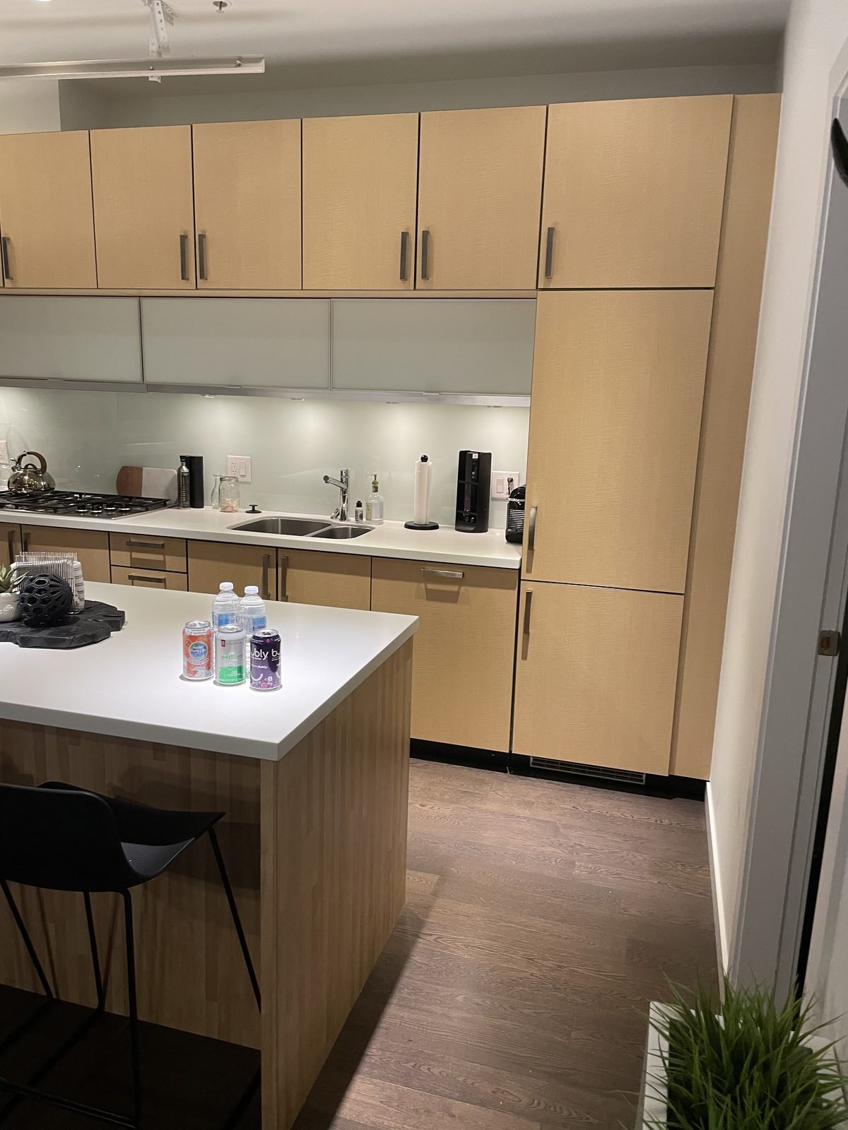 Before: tall maple pantry wall beside the island in a Downtown Vancouver condo kitchen