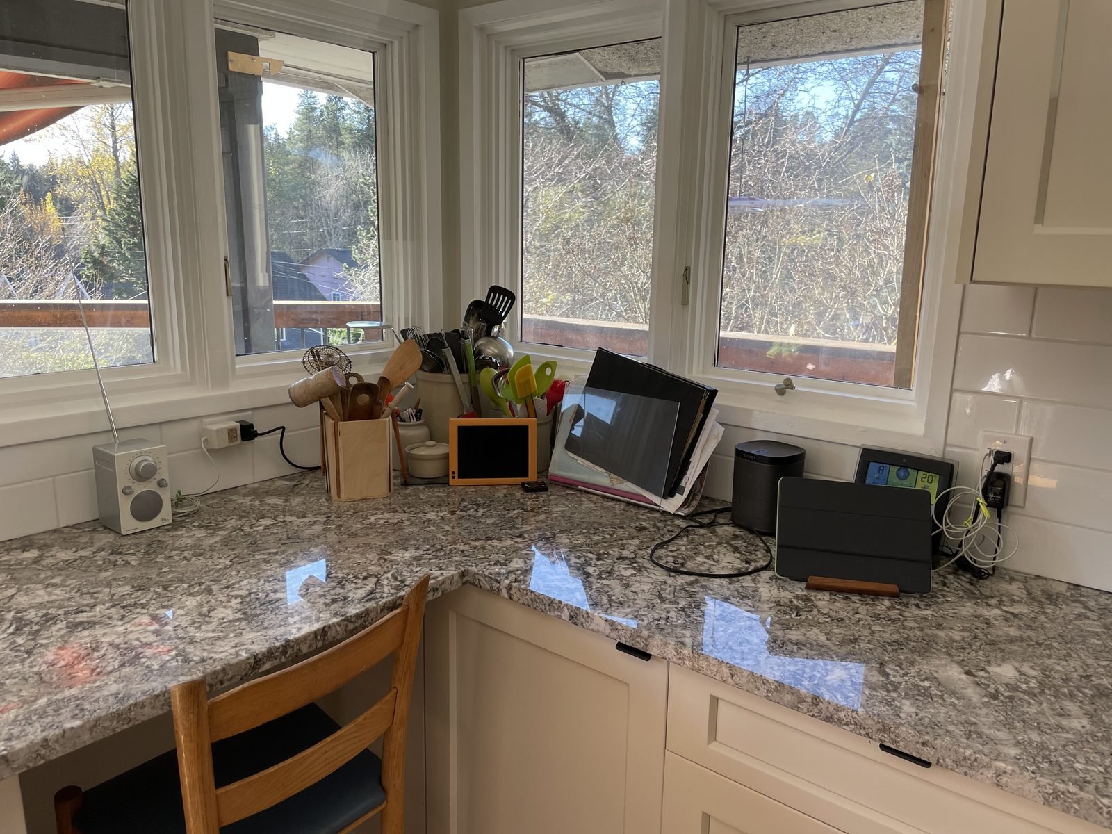 Granite corner counter under three windows in a renovated Dunbar, Vancouver kitchen