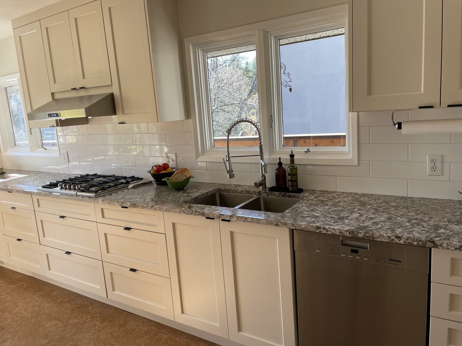 Stainless undermount double sink with granite countertops and a dishwasher in a Dunbar kitchen renovation