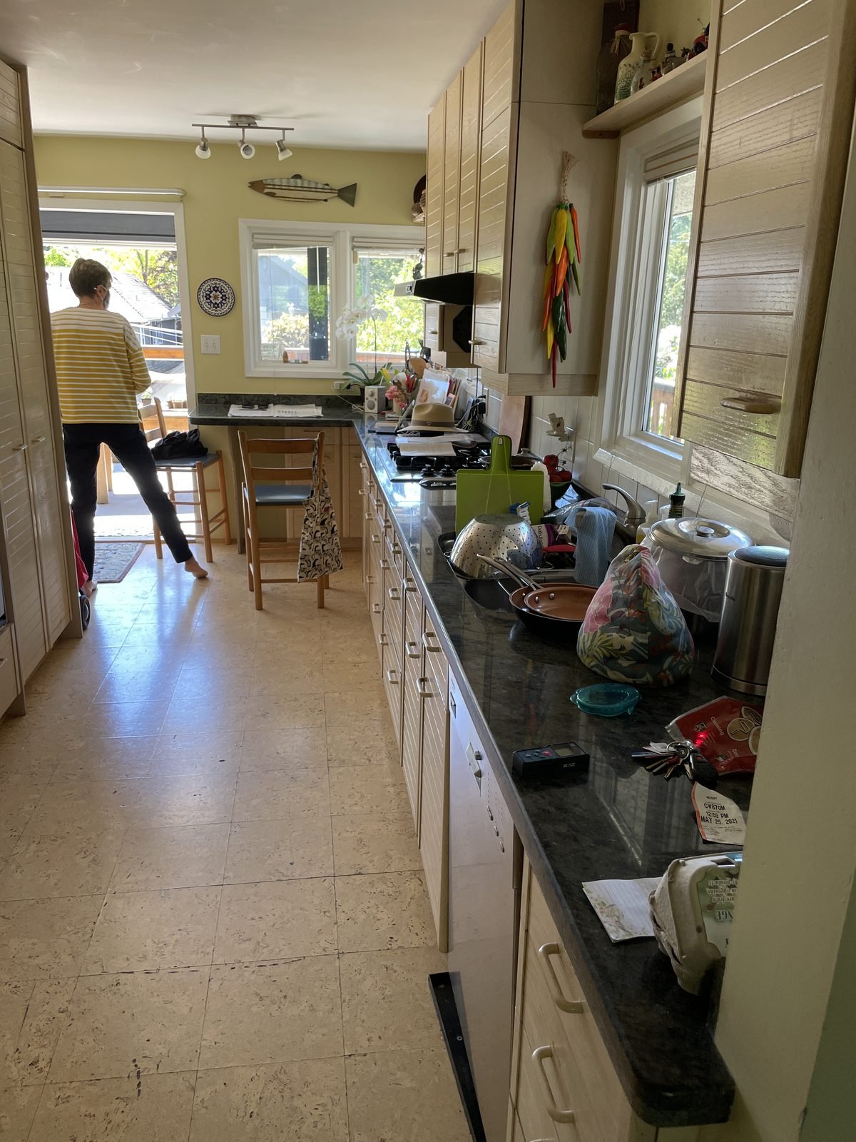 Before: galley view of the original Dunbar, Vancouver kitchen with maple cabinets