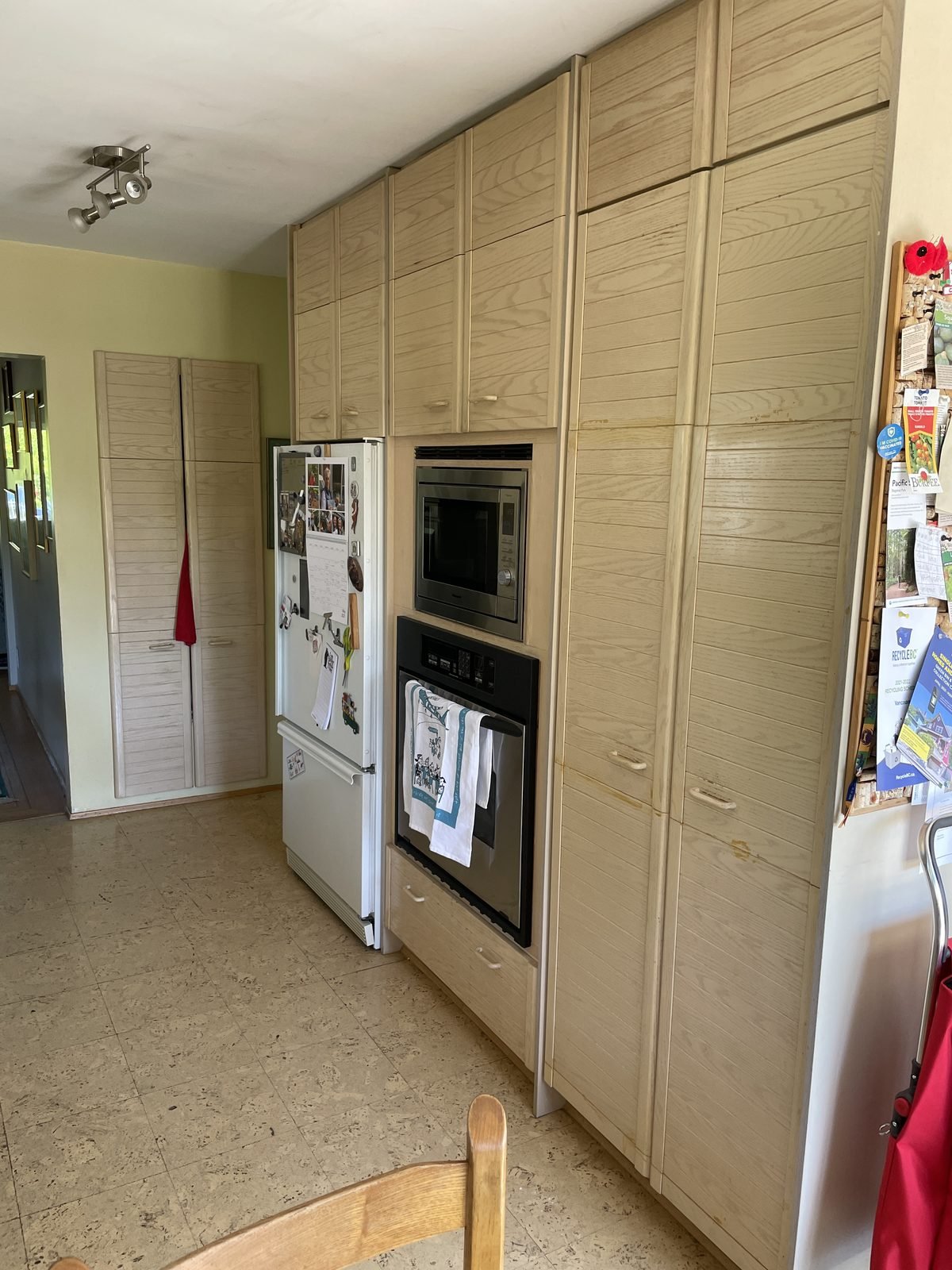 Before: tall maple pantry wall beside the fridge and wall oven in a Dunbar kitchen