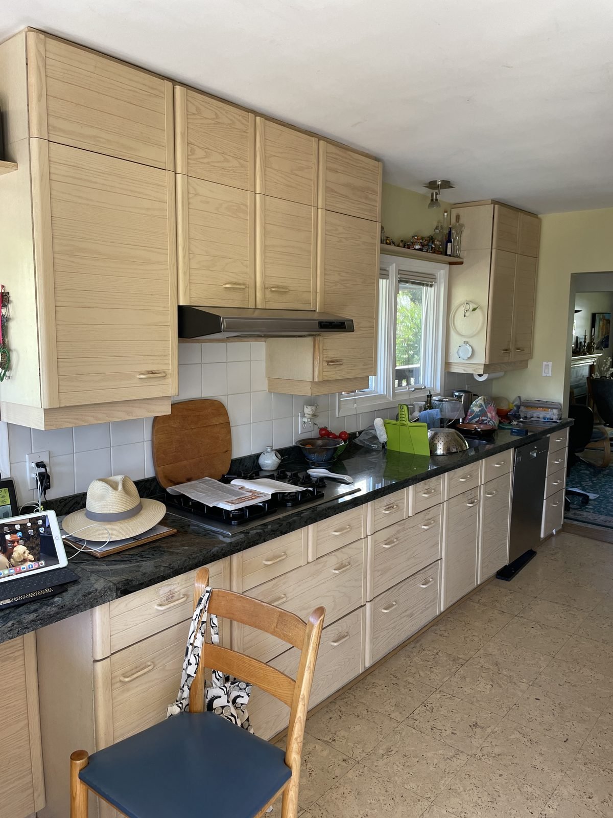 Before: light maple slab cabinets and black granite counters in a Dunbar, Vancouver kitchen