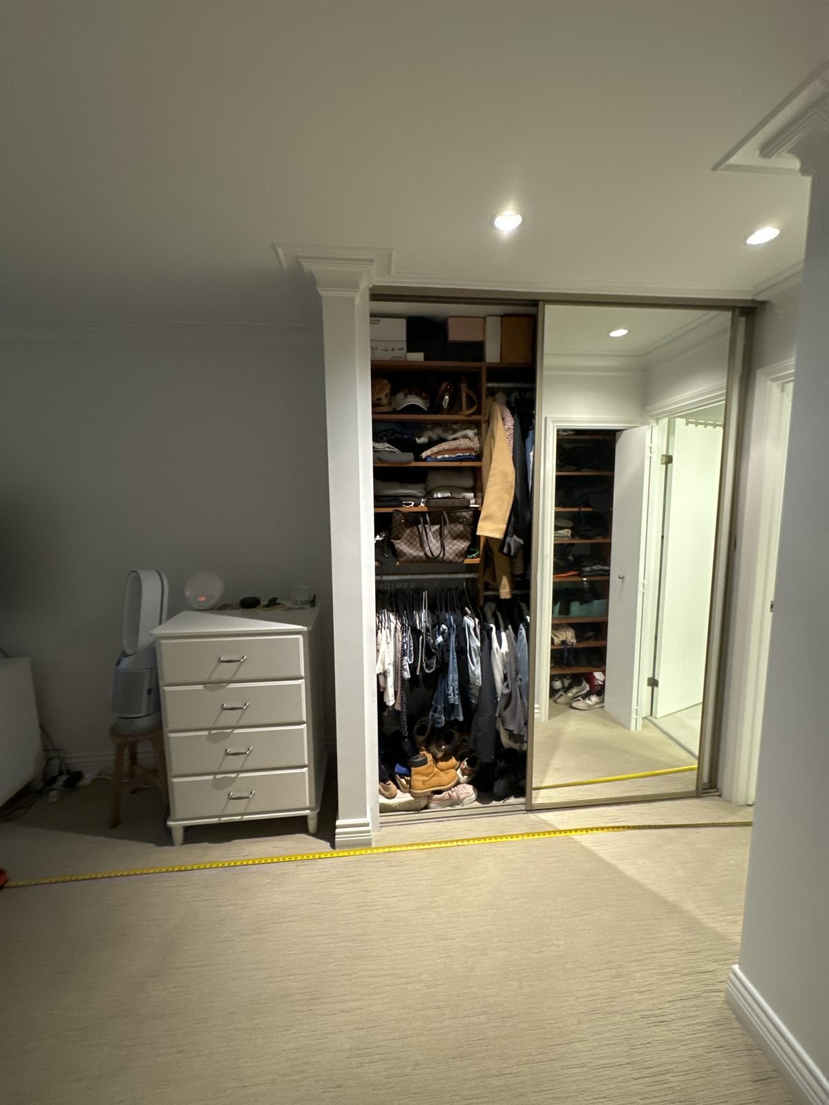 Before: primary bedroom with a sliding mirrored closet in a Fairview condo