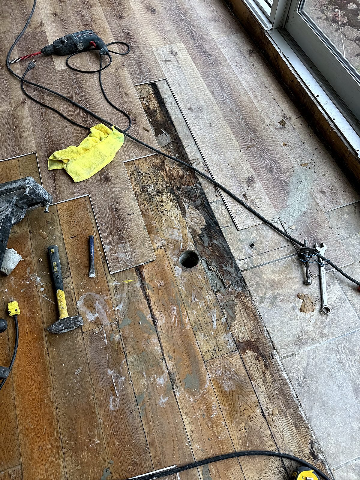 Flooring lifted and a core hole drilled for new sink drainage