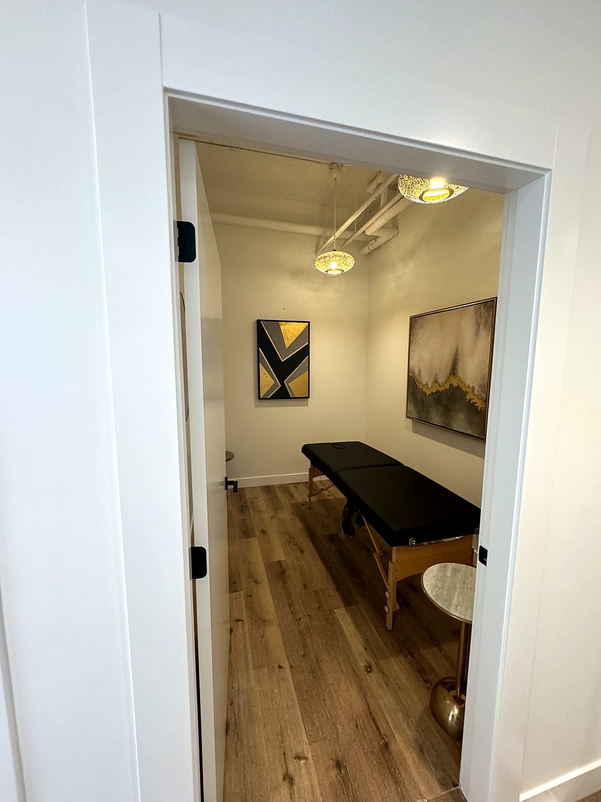 New treatment room with a solid core door, created by dividing a former recovery room