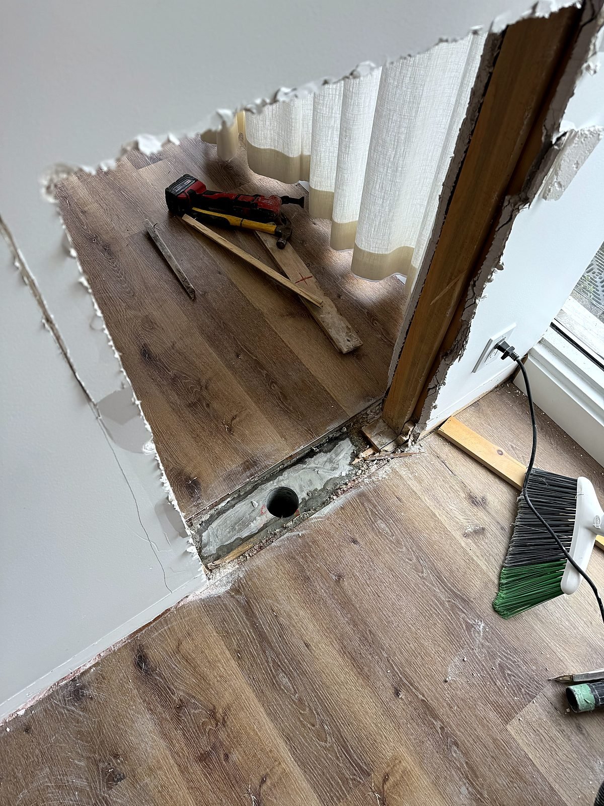 Wall opened and slab cored to run plumbing for a new treatment room sink
