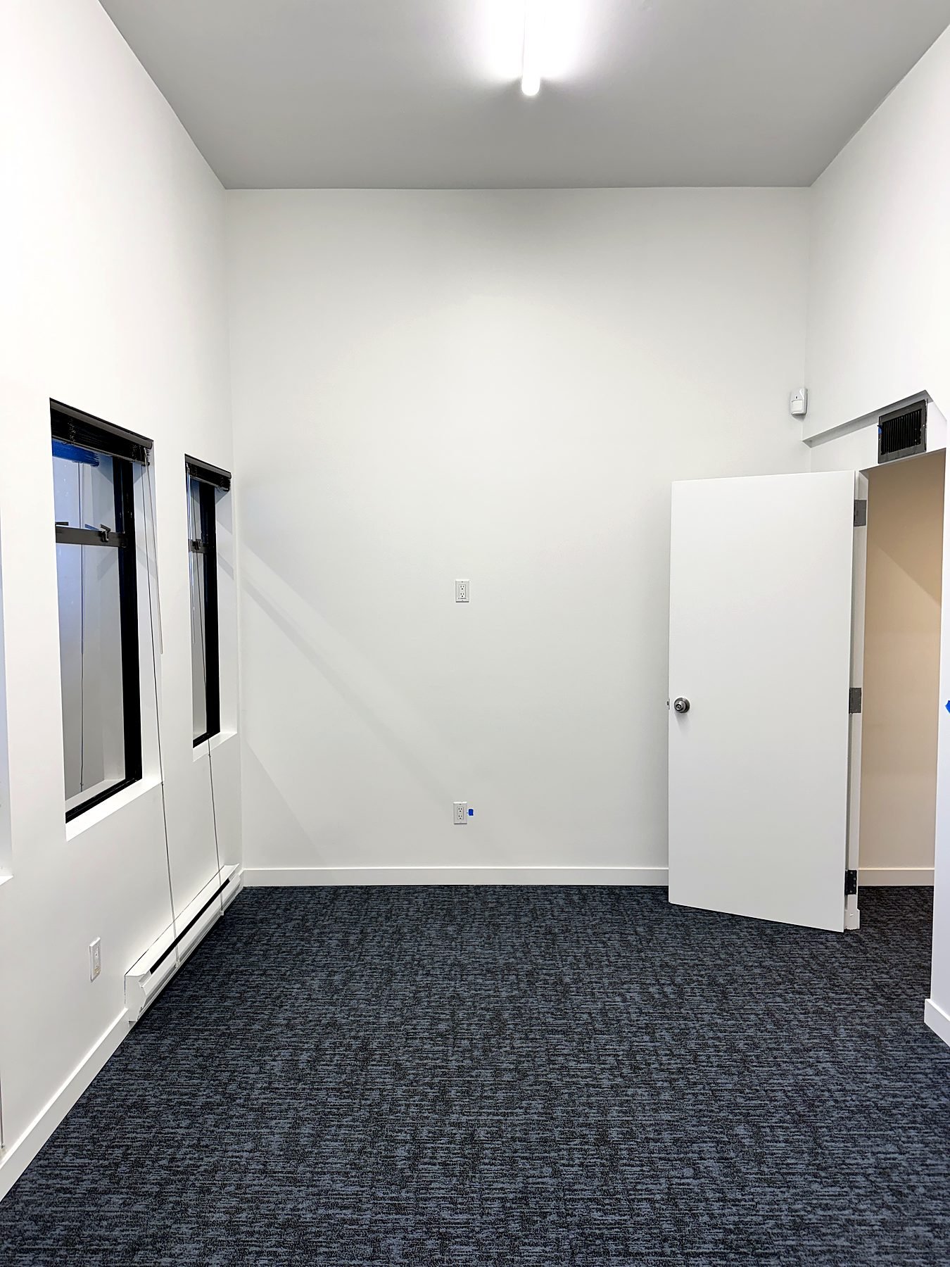 Main meeting room after renovation with fresh paint and new carpet in a Burnaby office