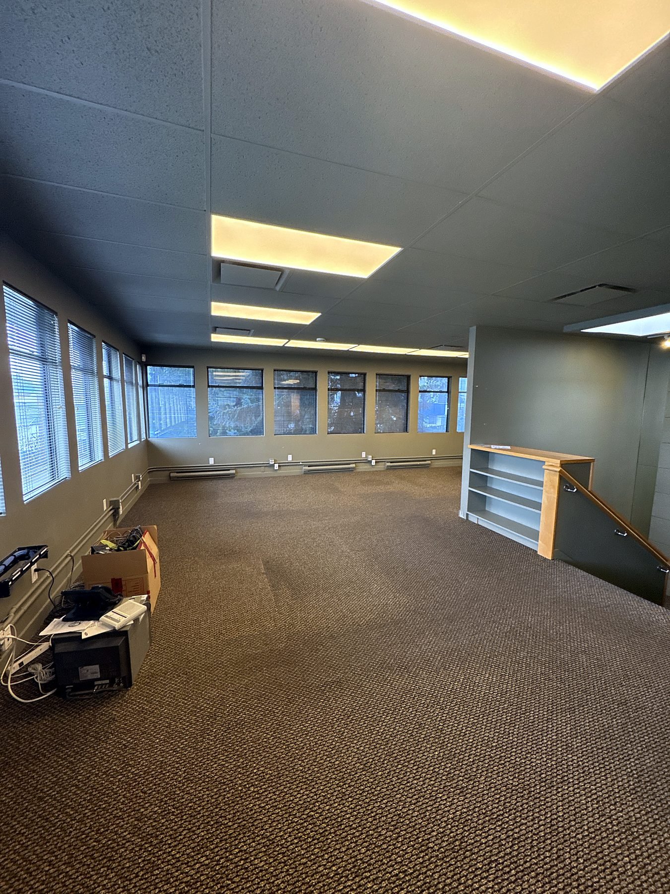 Upper floor of the Burnaby office before renovation with worn carpet and old finishes