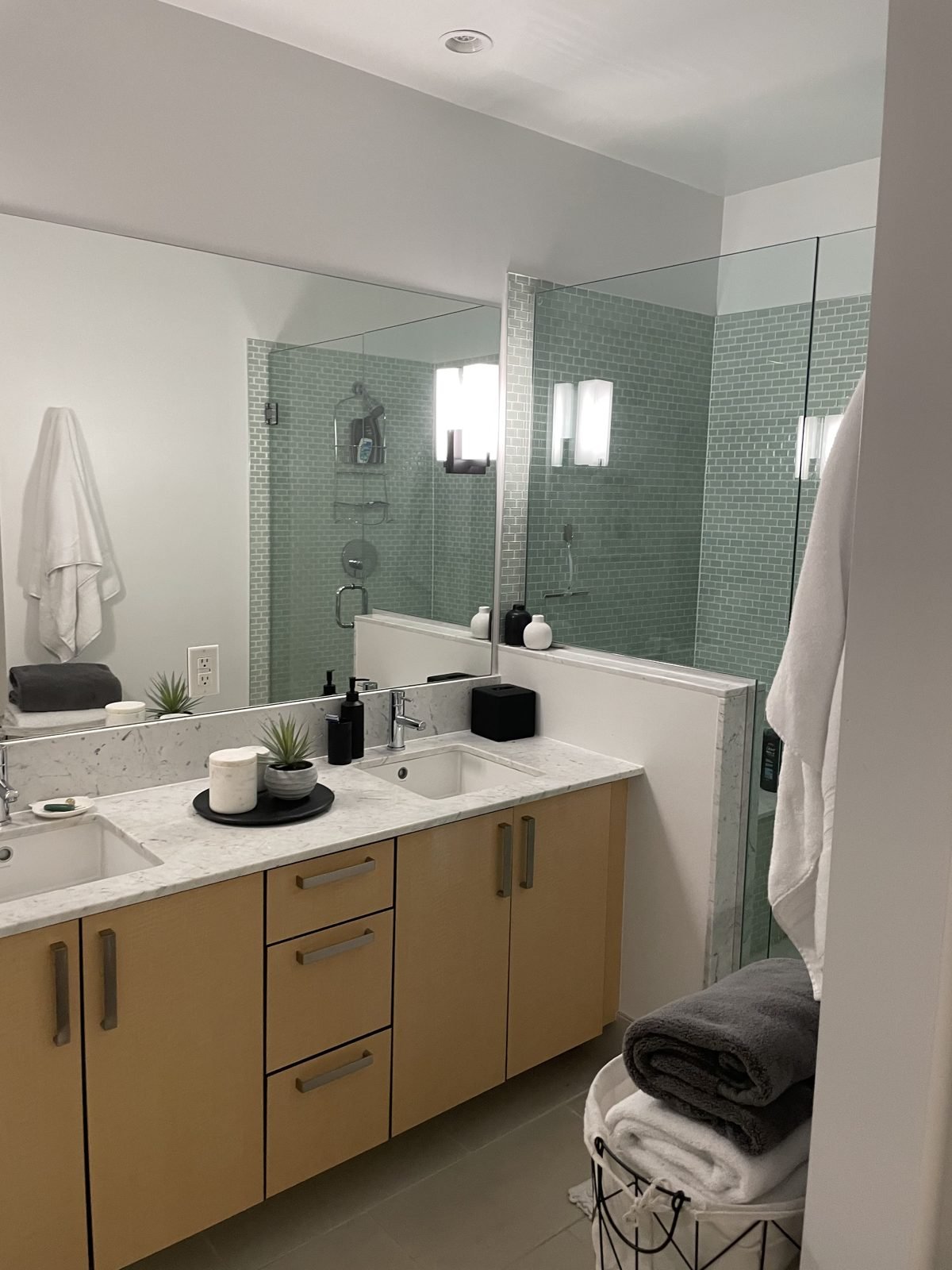 Before: condo ensuite with a maple double vanity and green glass mosaic shower in Gastown