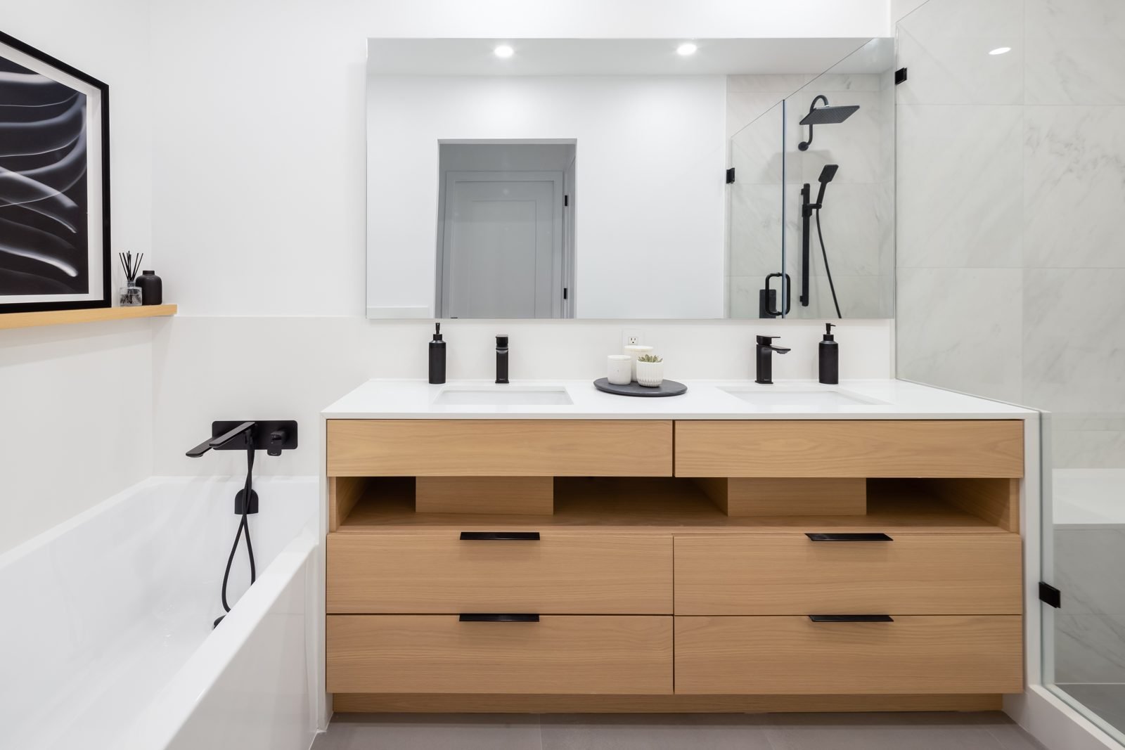 Renovated Gastown condo ensuite with a double vanity and soaker tub