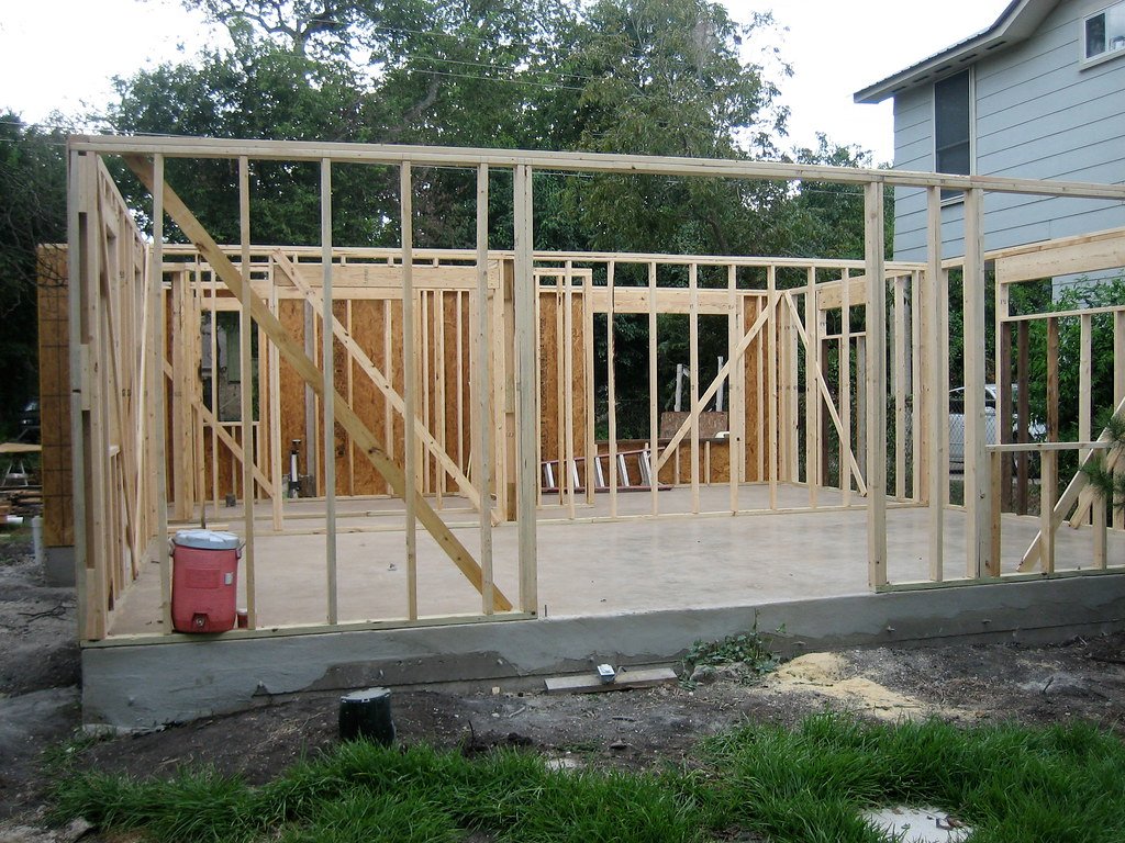 Wood framing for a new home addition going up beside an existing house