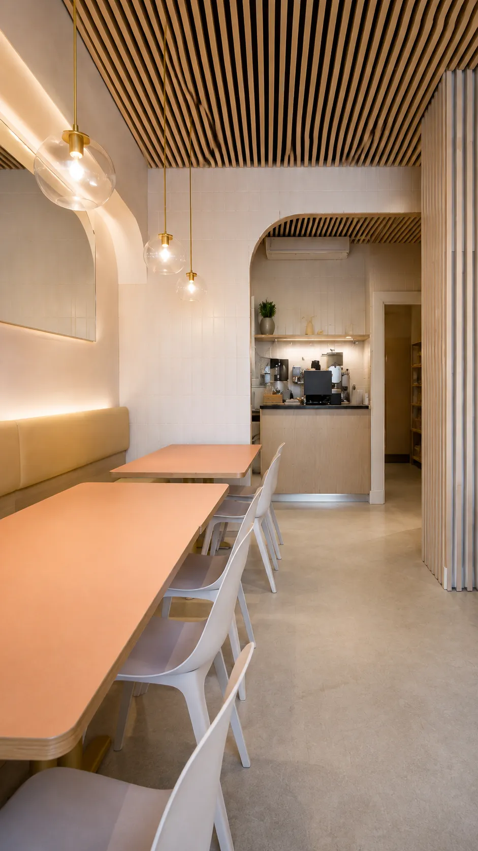 Completed Downtown Vancouver restaurant renovation featuring curved walls, custom dining areas, warm wood details and pendant lighting