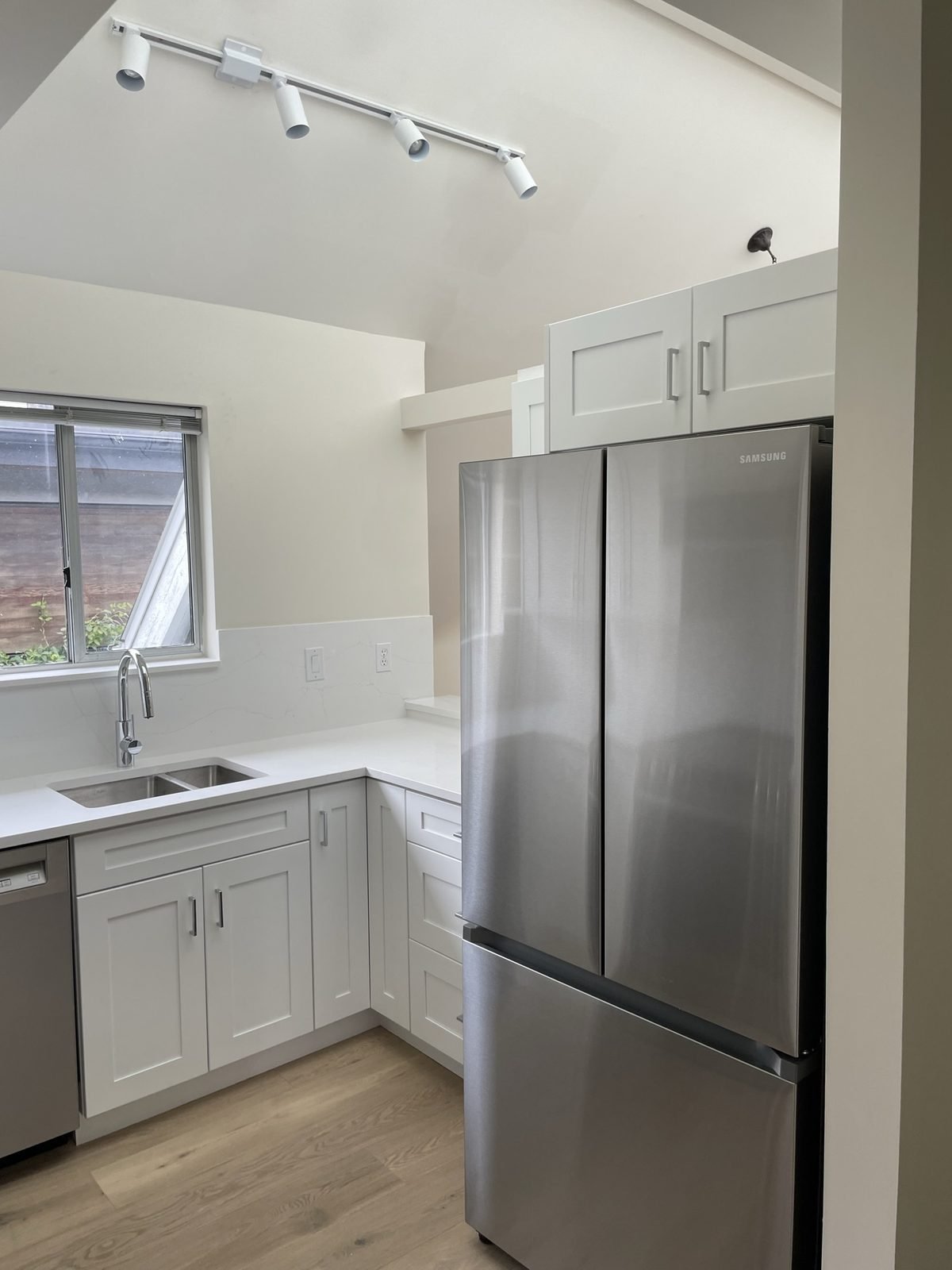 French-door fridge and white shaker cabinets in a renovated Kitsilano, Vancouver condo kitchen