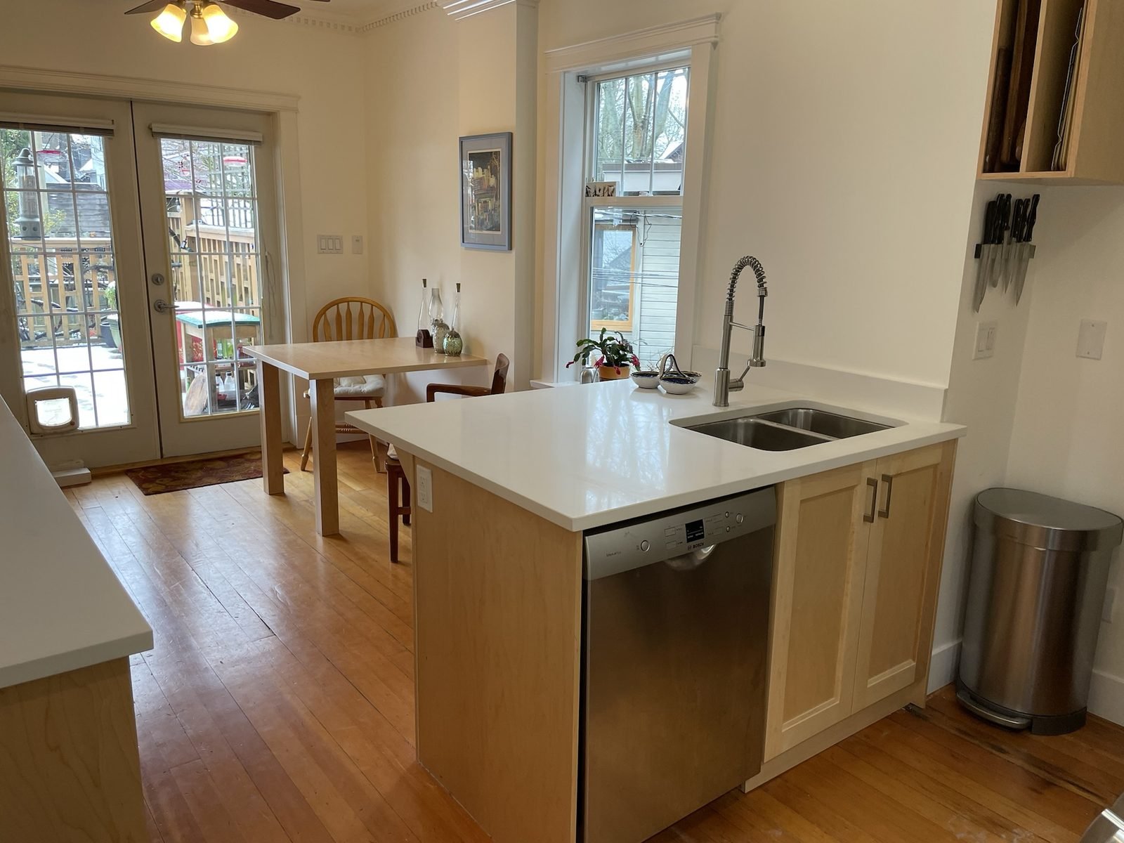 Custom Kitsilano kitchen with maple shaker cabinets, a white quartz island and new patio doors