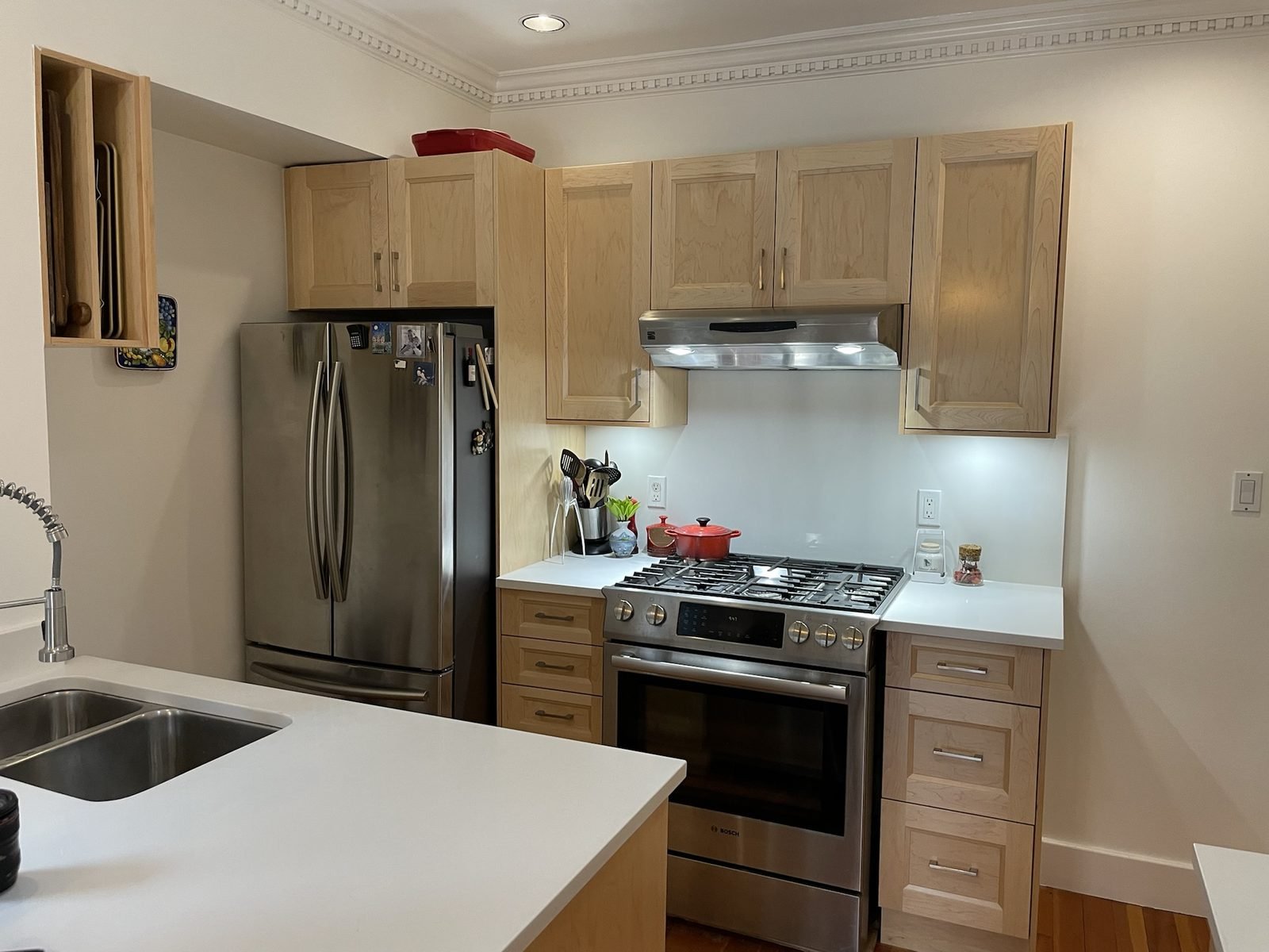 Maple shaker kitchen with a white quartz island and undermount double sink in a Kitsilano home