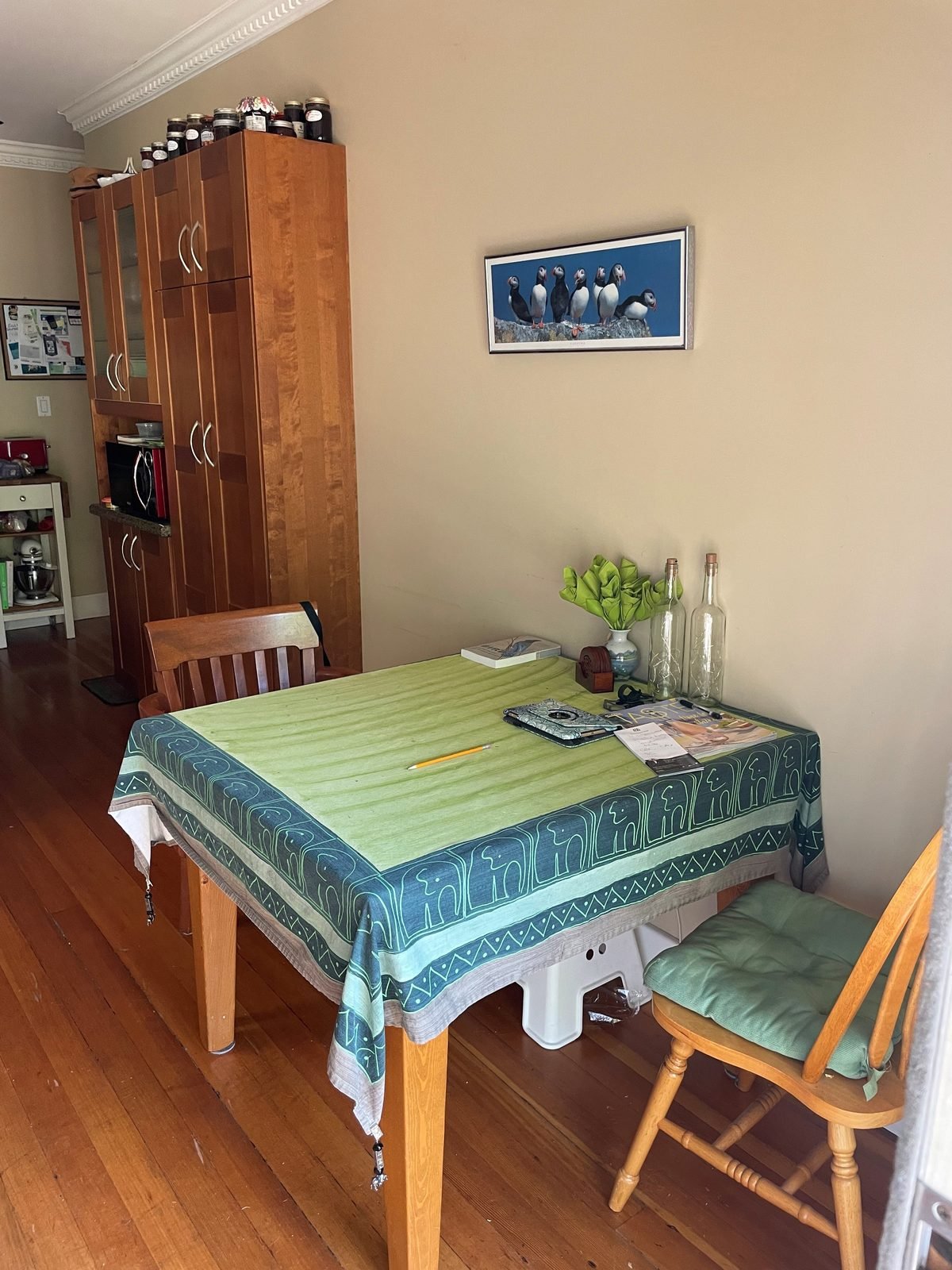 Before: dining corner with a tall wood cabinet beside the kitchen in a Kitsilano house