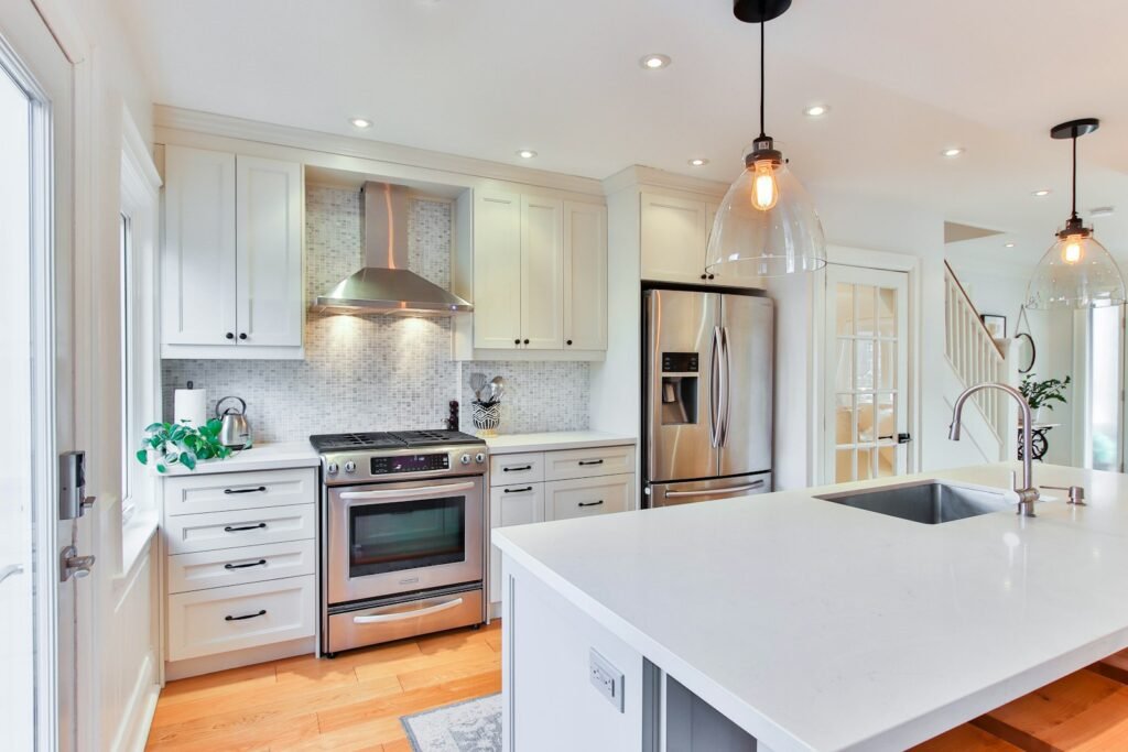 L-shaped kitchen with white cabinets and counters