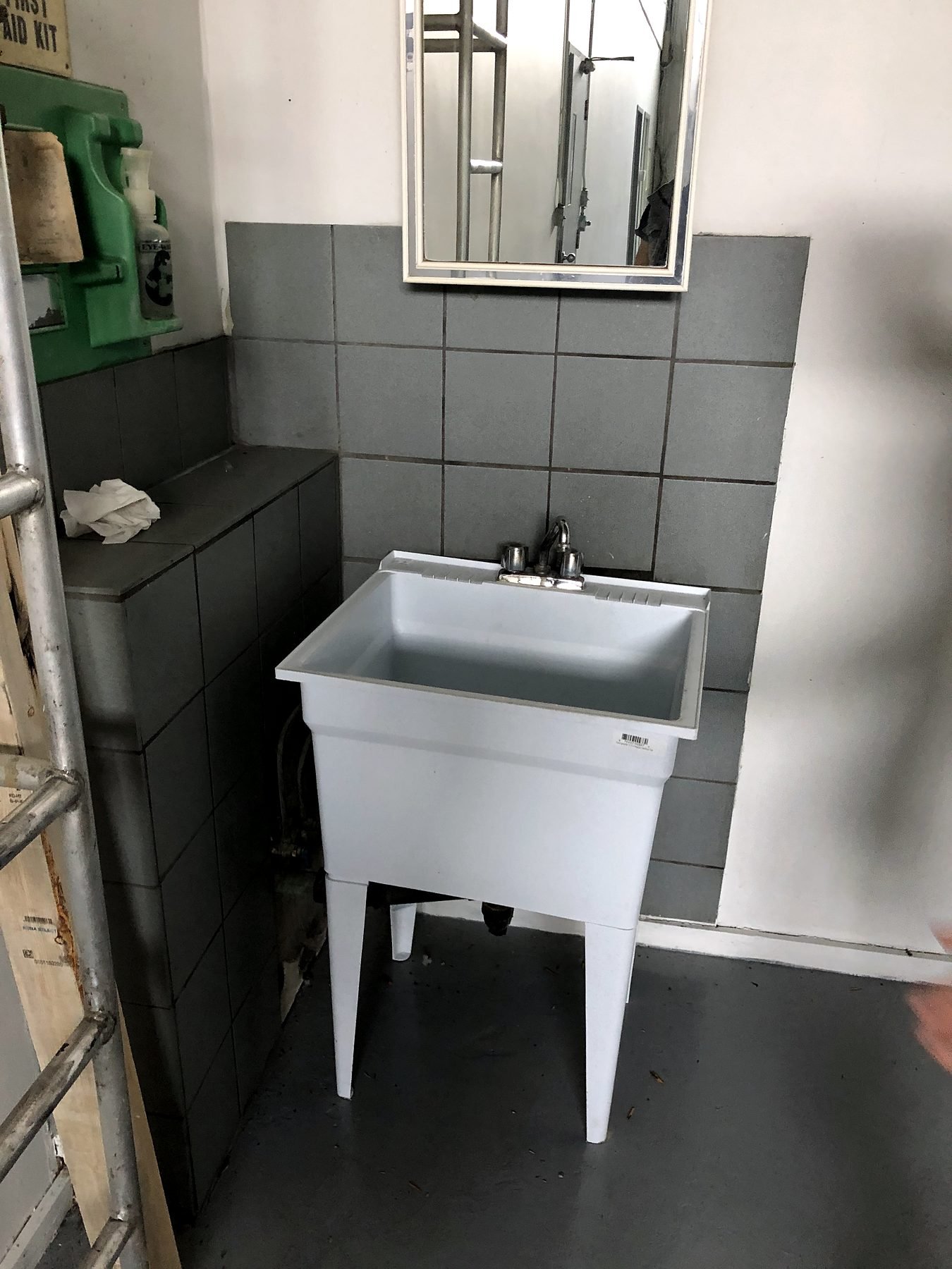 Old utility sink in the warehouse before new plumbing was installed