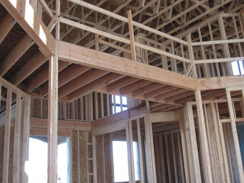 Interior wood framing for a two-storey section of a house under construction