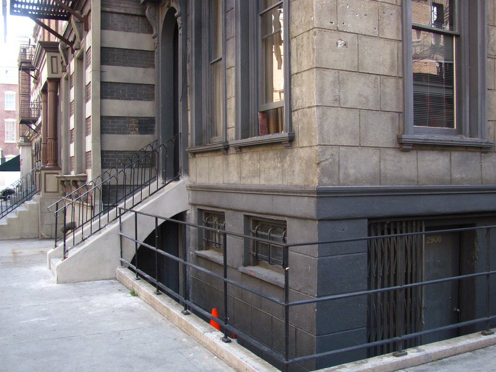 Exterior steps leading down to a separate basement suite entrance below street level