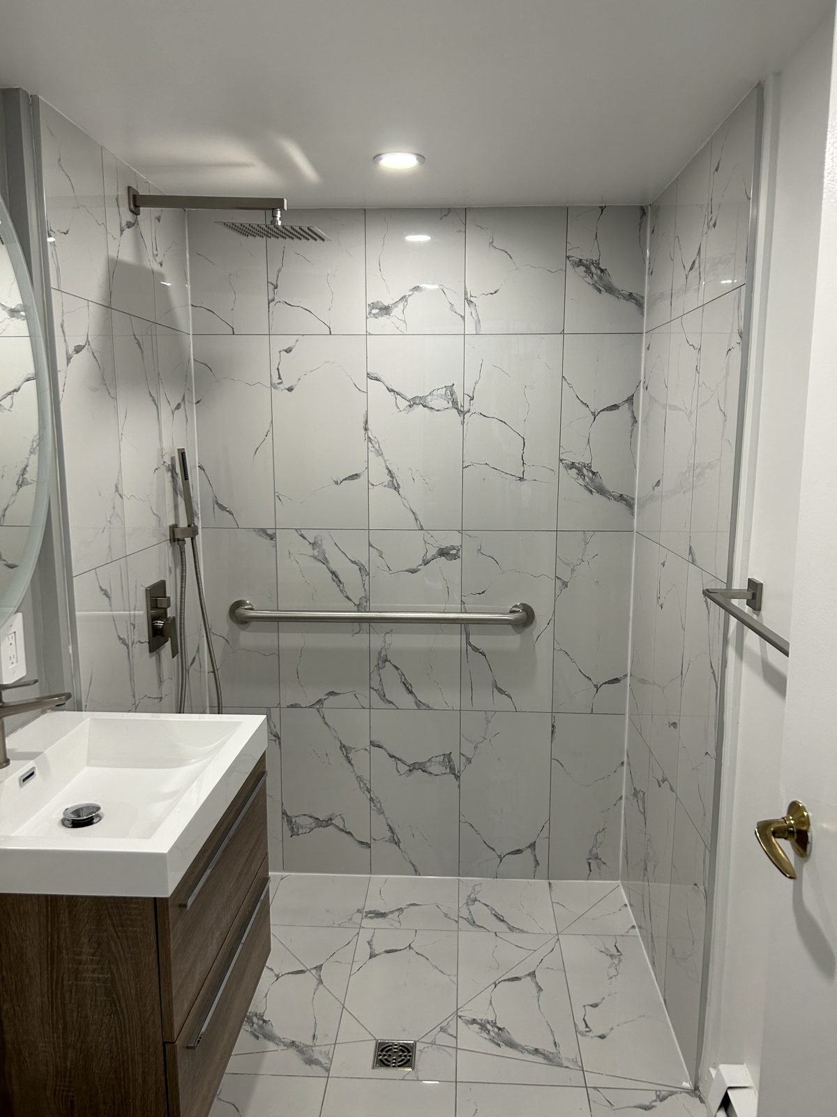 Aging-in-place bathroom with a step-free walk-in shower, rain head, hand shower and grab bar in Shaughnessy, Vancouver