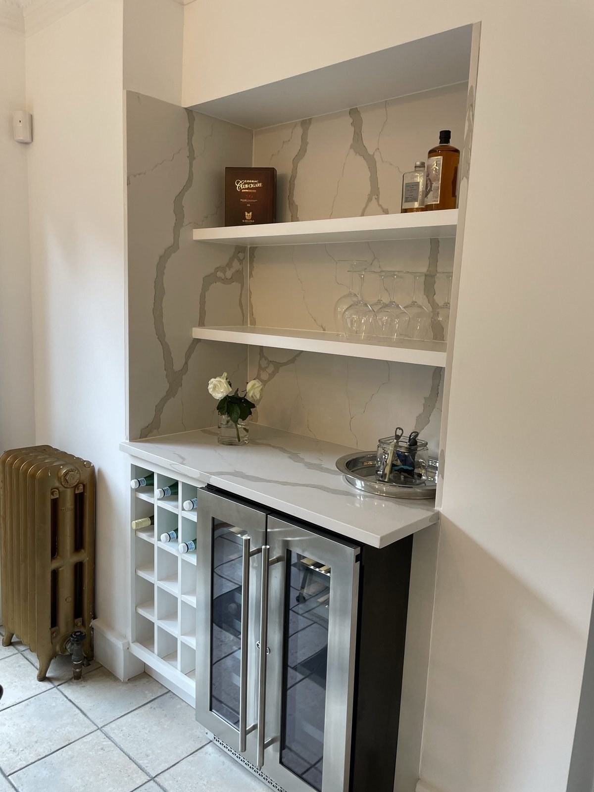 Custom dry bar with quartz backsplash, floating shelves, wine cubbies and a beverage fridge in a Shaughnessy home