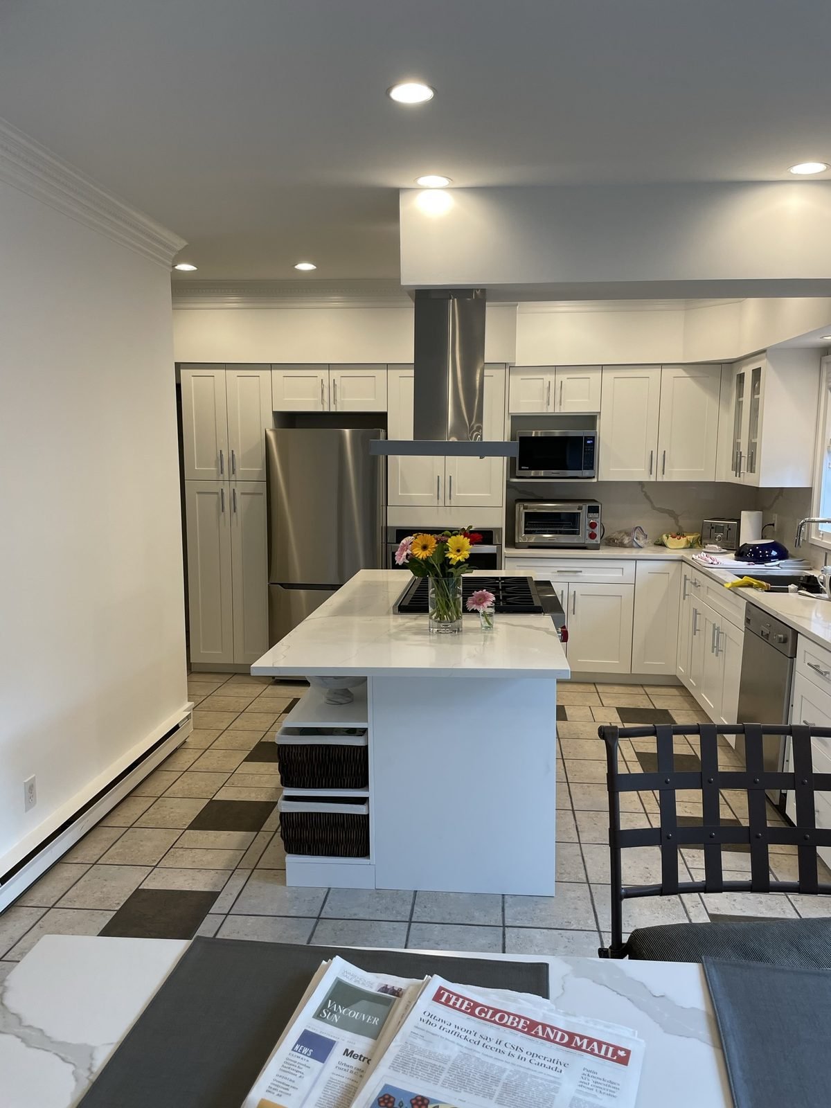 Full view of a renovated Shaughnessy kitchen with white custom cabinetry, stainless appliances and quartz countertops