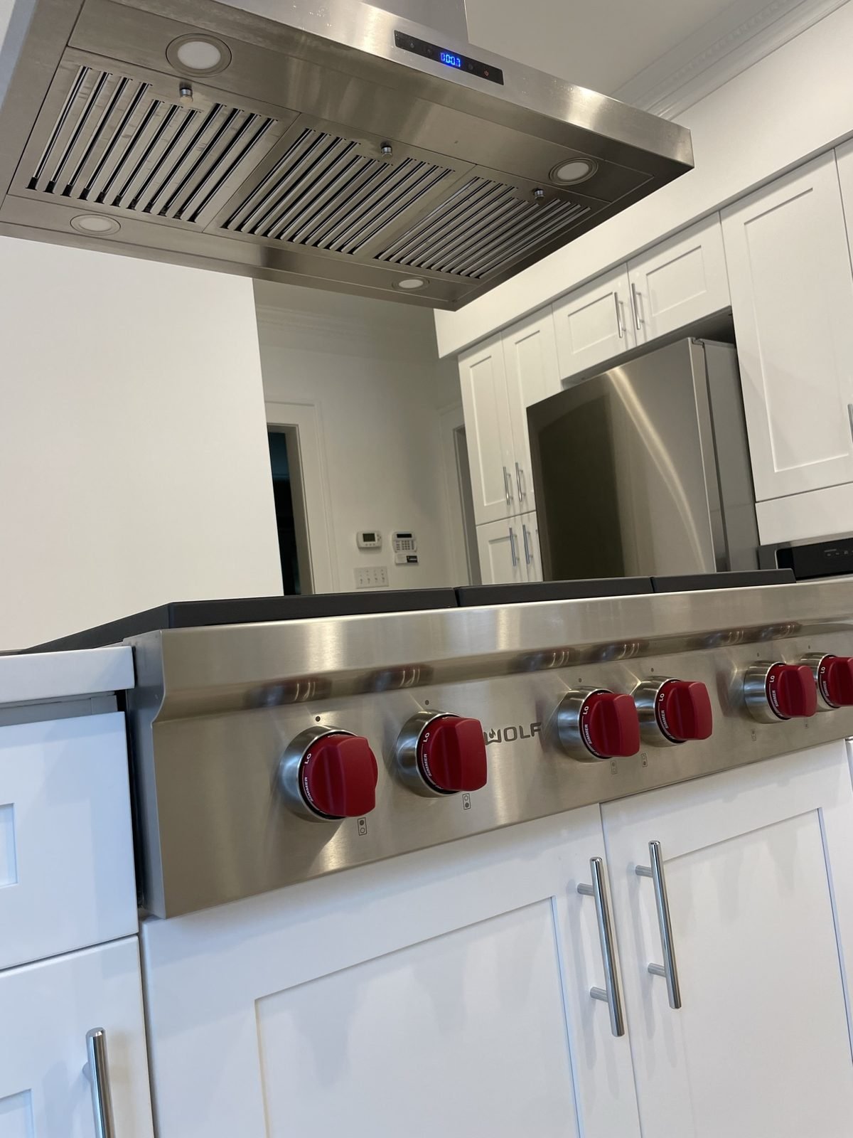 Stainless island hood and gas rangetop detail in a renovated Shaughnessy kitchen