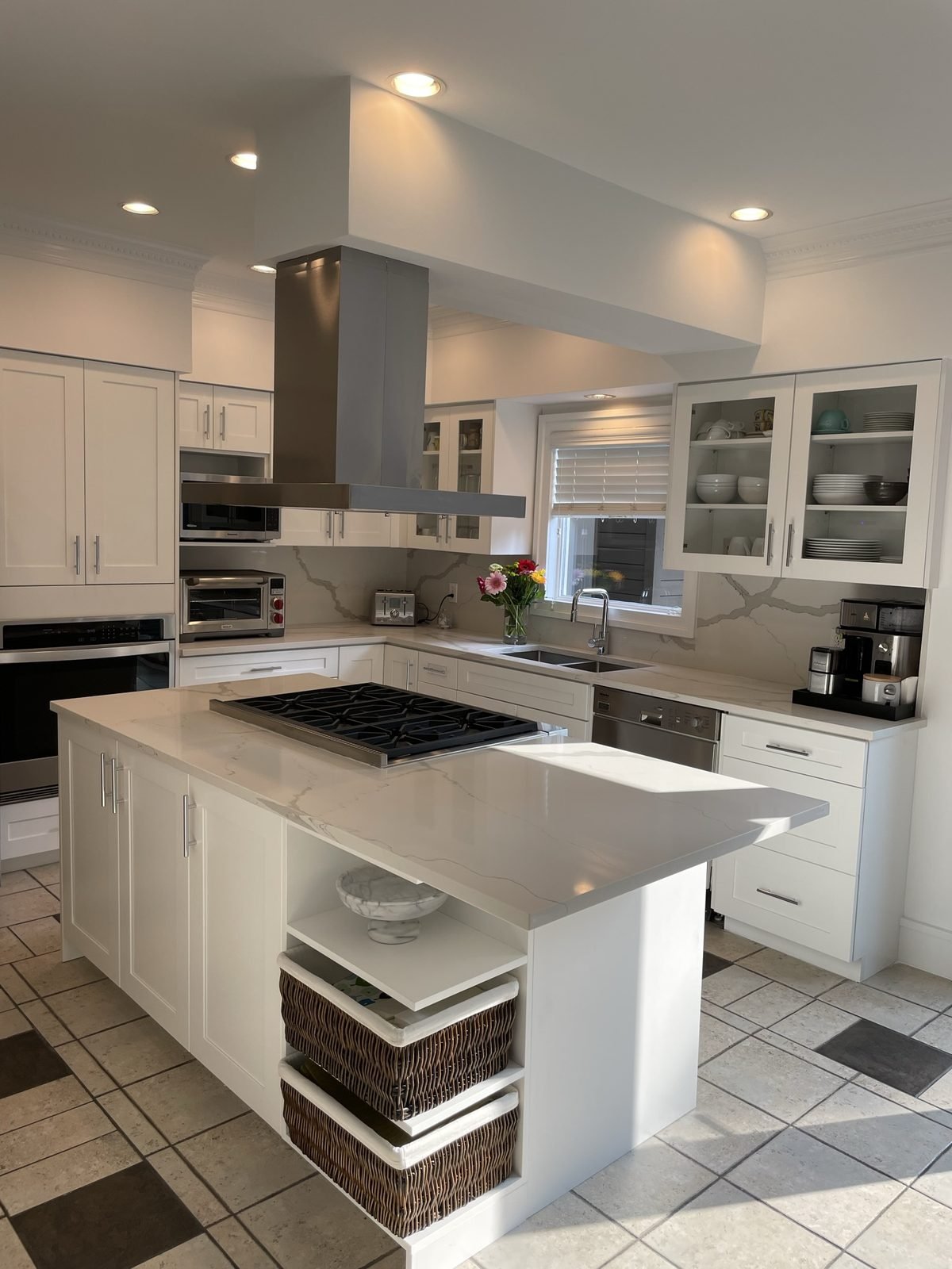Custom Shaughnessy kitchen with white shaker cabinets, a quartz island with gas rangetop and a stainless island hood