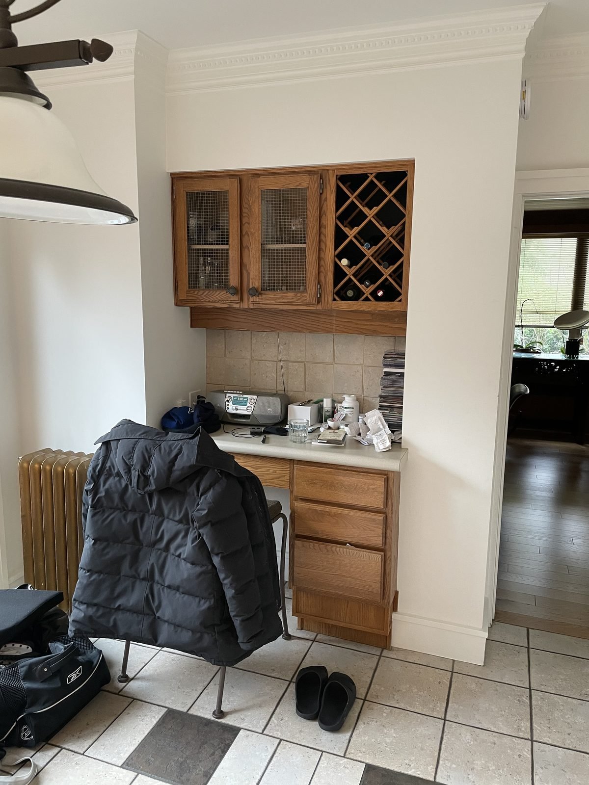 Before: built-in desk niche with oak wine-rack cabinets that became the new dry bar