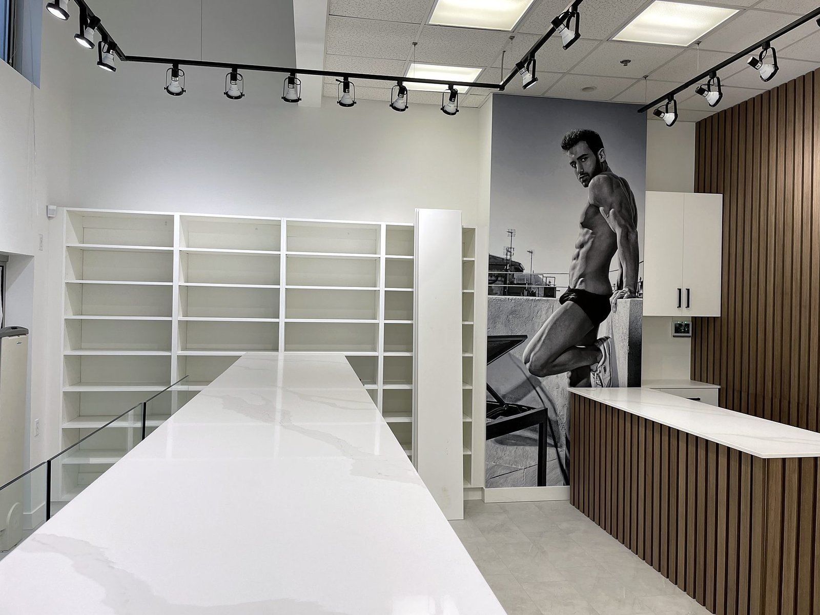 Completed retail store with slat wall, quartz countertops and track lighting before merchandise was installed