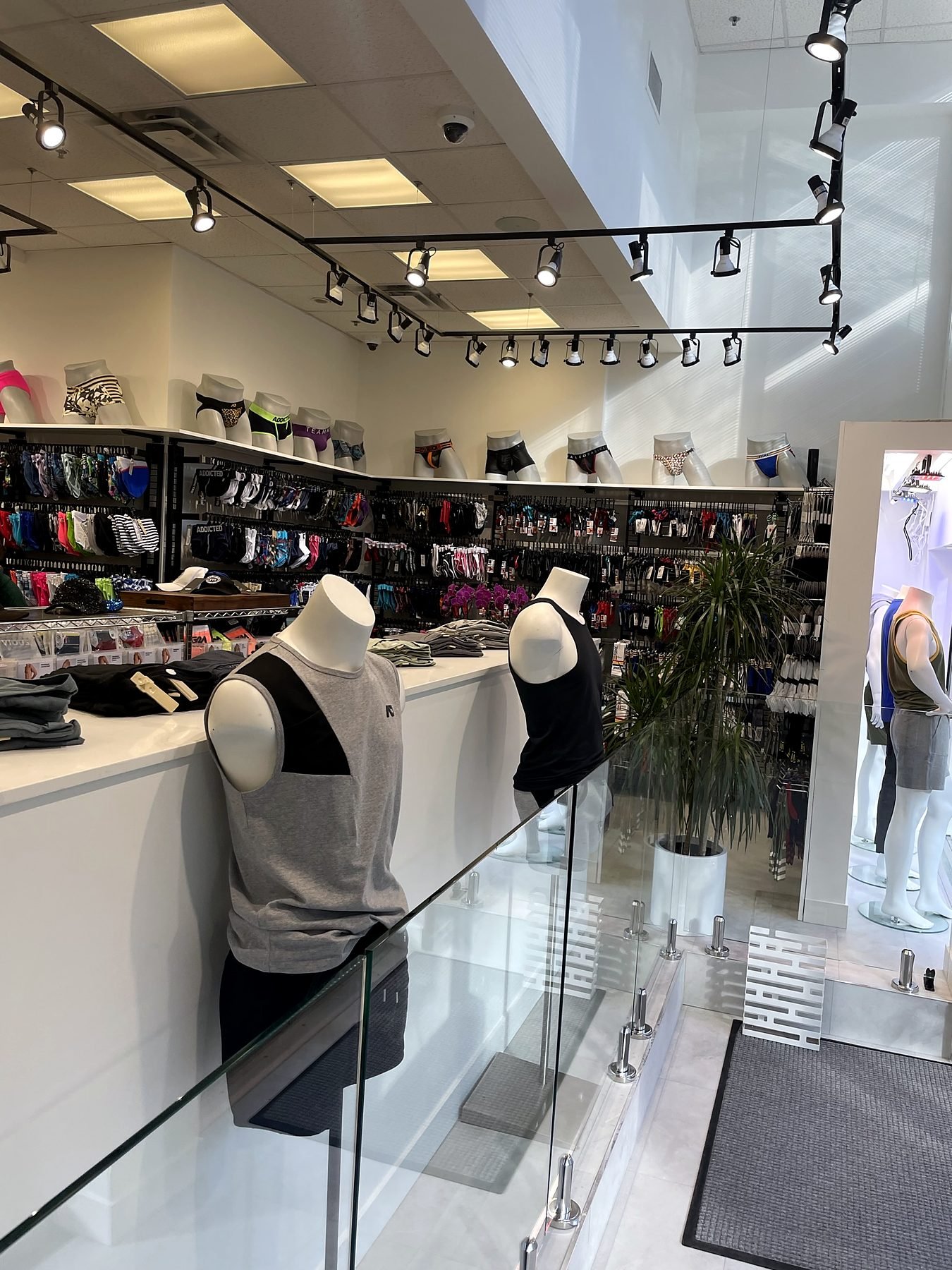 Frameless glass railing at the entry level of the renovated store