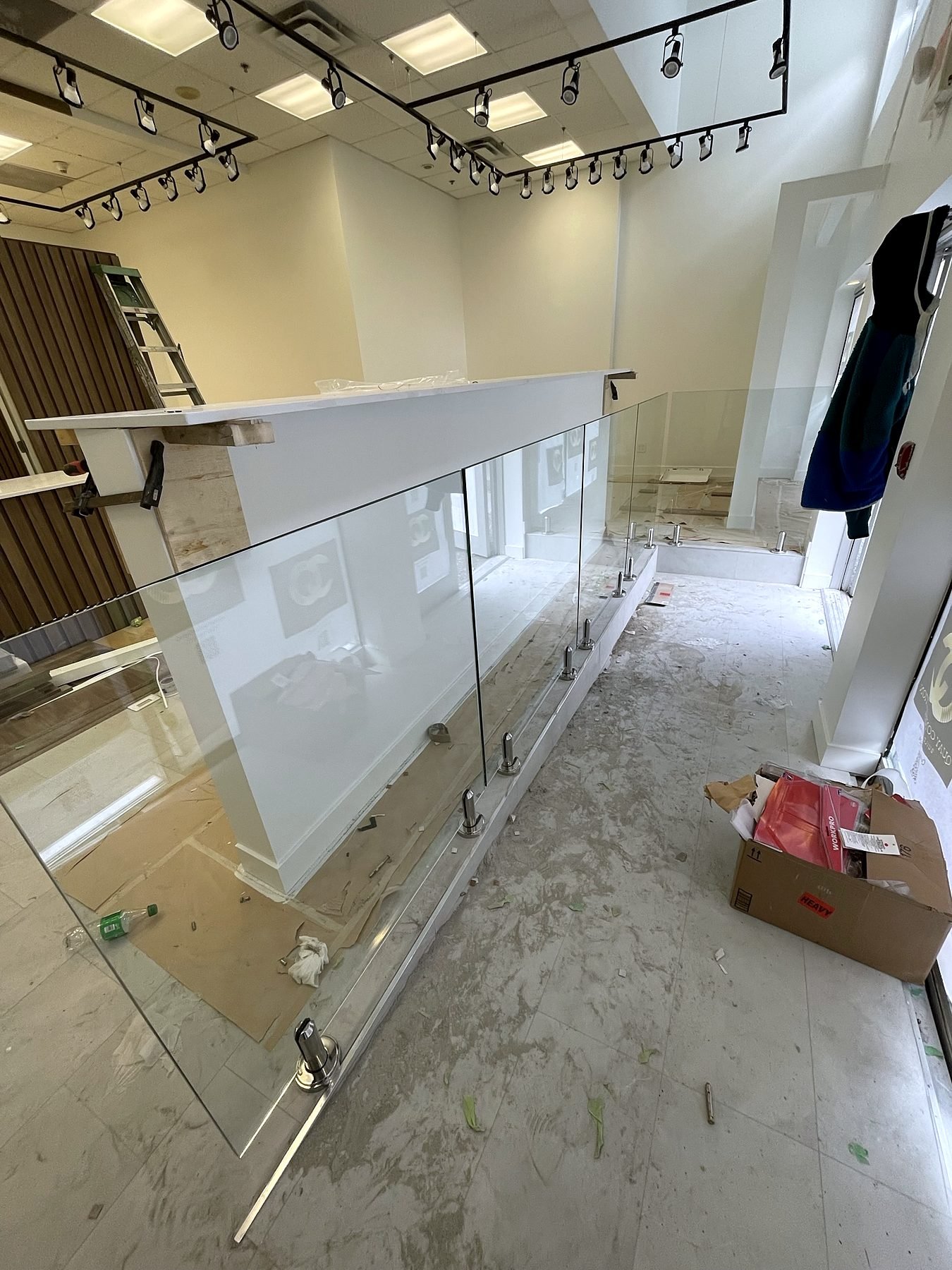 Frameless glass railings being installed at the store entry
